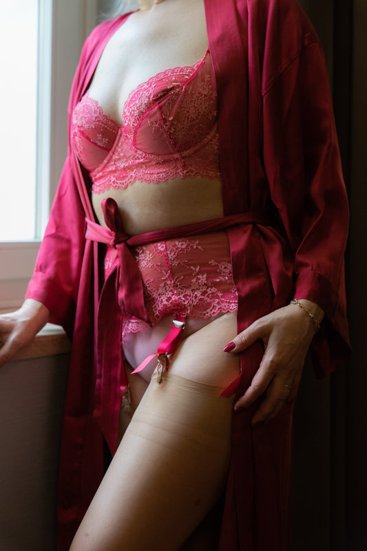 hot pink demi cup lace Judith bra, shown with matching 6 strap garter belt, on model