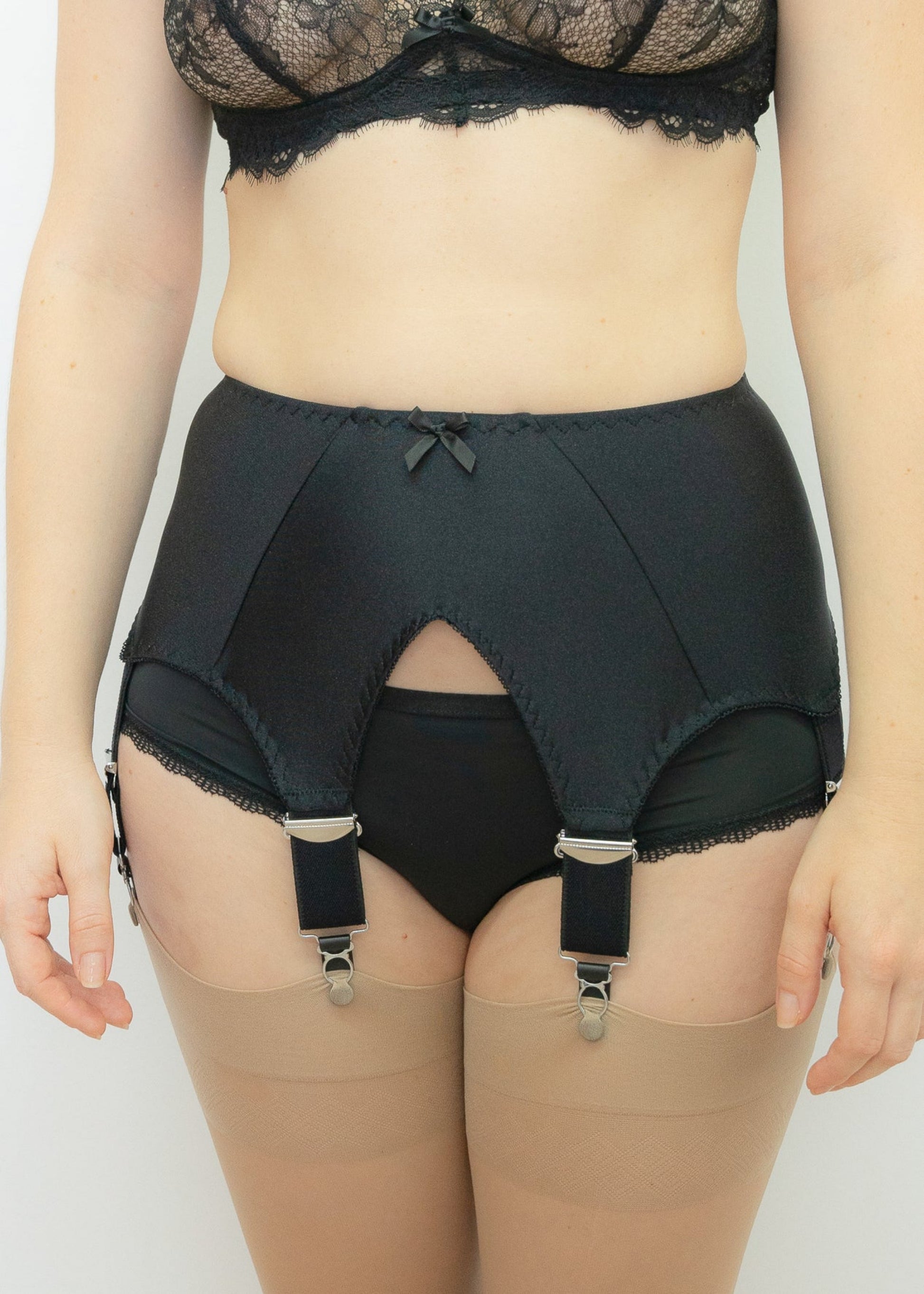 A black wide Iris garter belt with a deep V-style design, featuring six extra wide adjustable straps