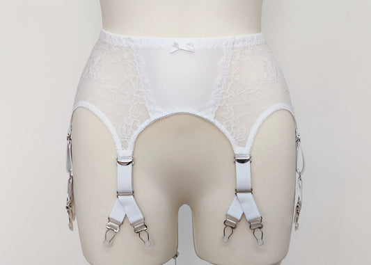 A white lace Rita garter belt with 6 Y-straps and a bow detail, displayed on a mannequin.