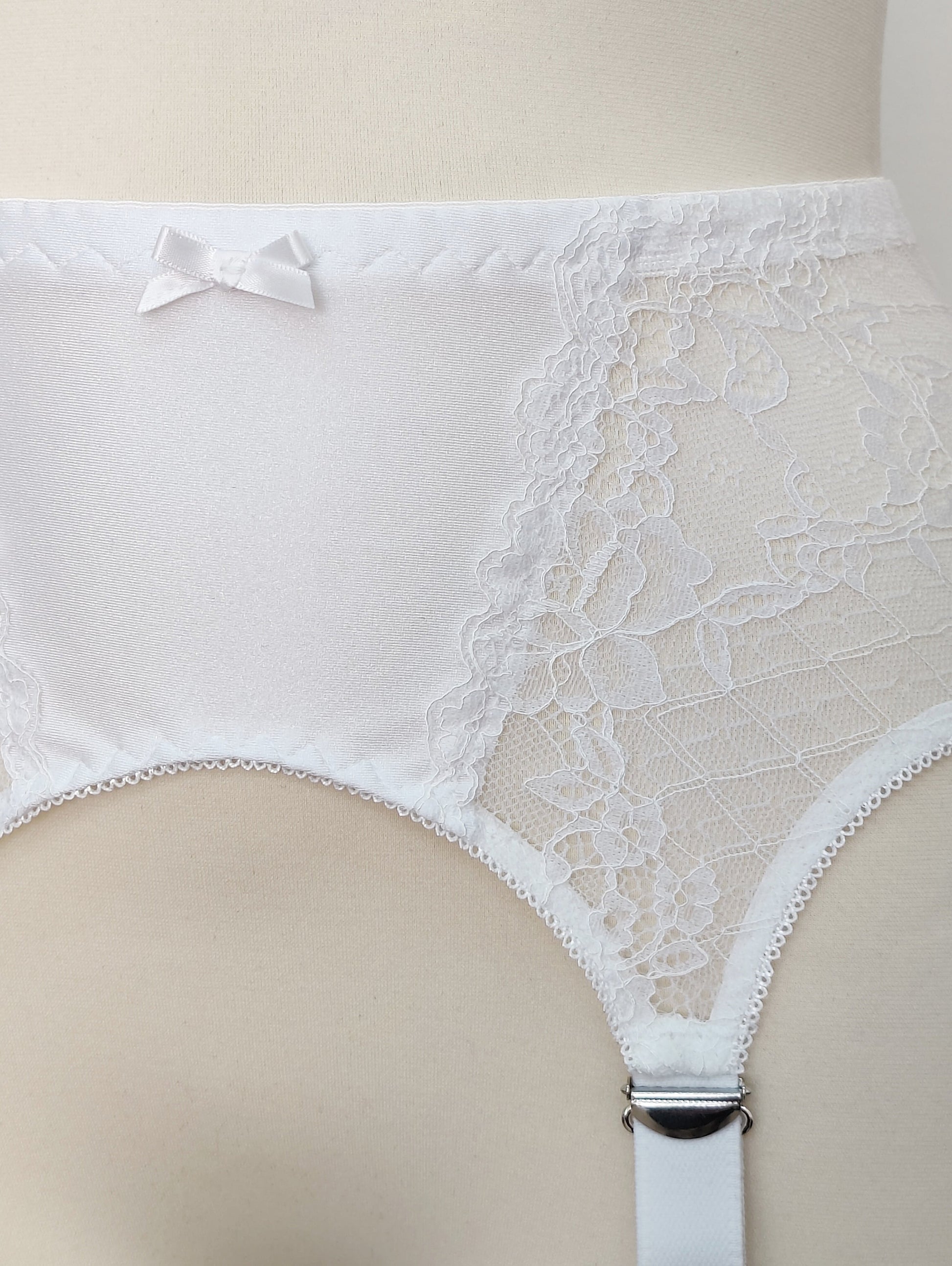 A white lace Rita garter belt with 6 Y-straps and a bow detail, lace detail
