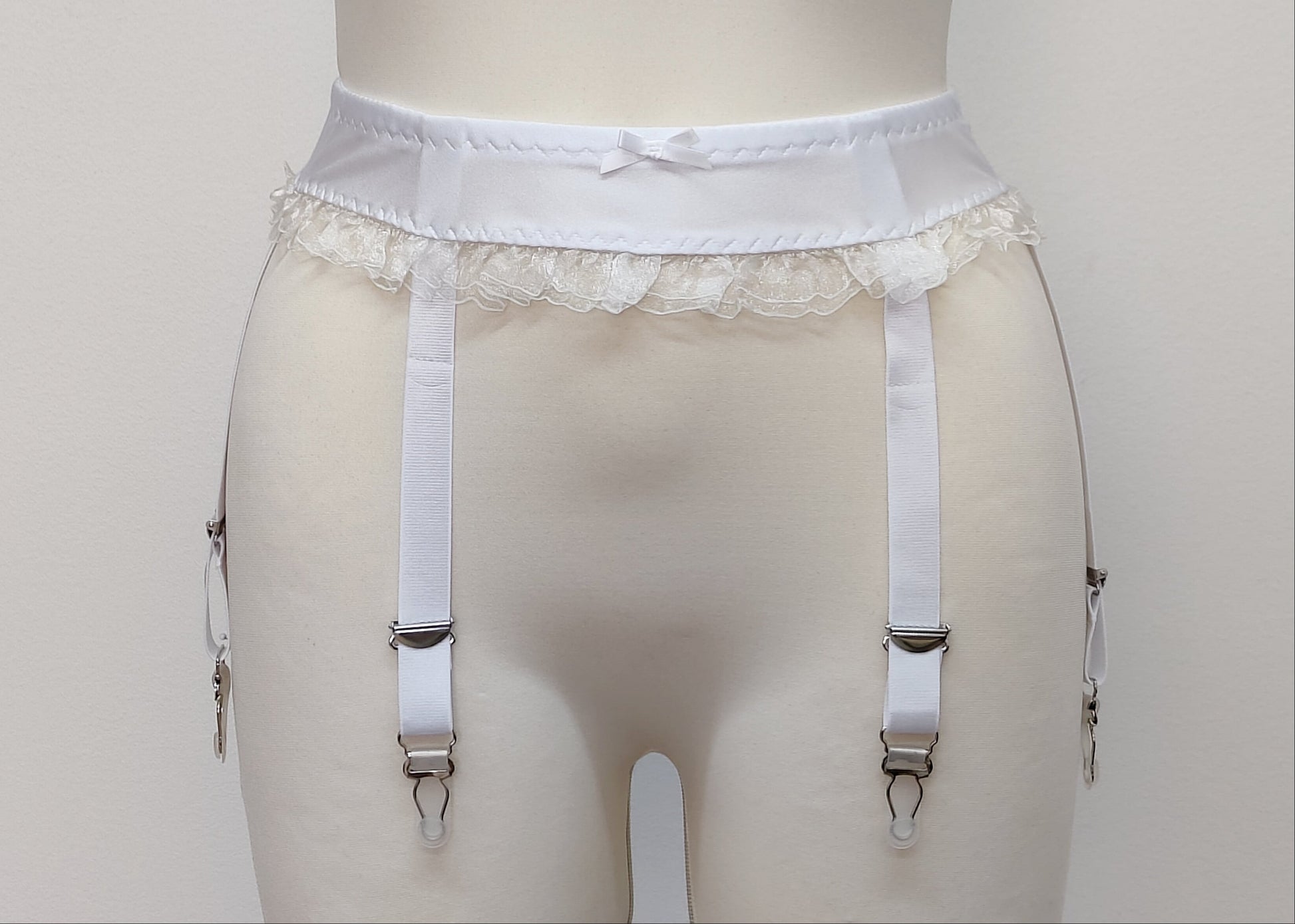 white narrow 60's style Summer garter belt with ruffle trim and 6 straps