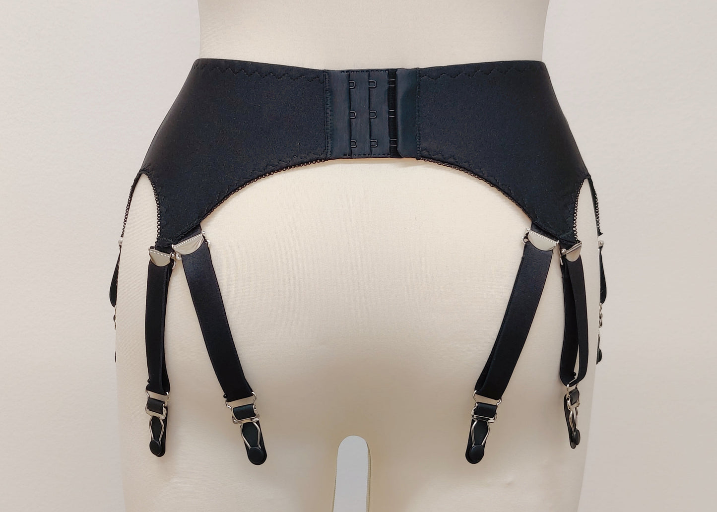 A black Nina garter belt with additional straps attached to the back