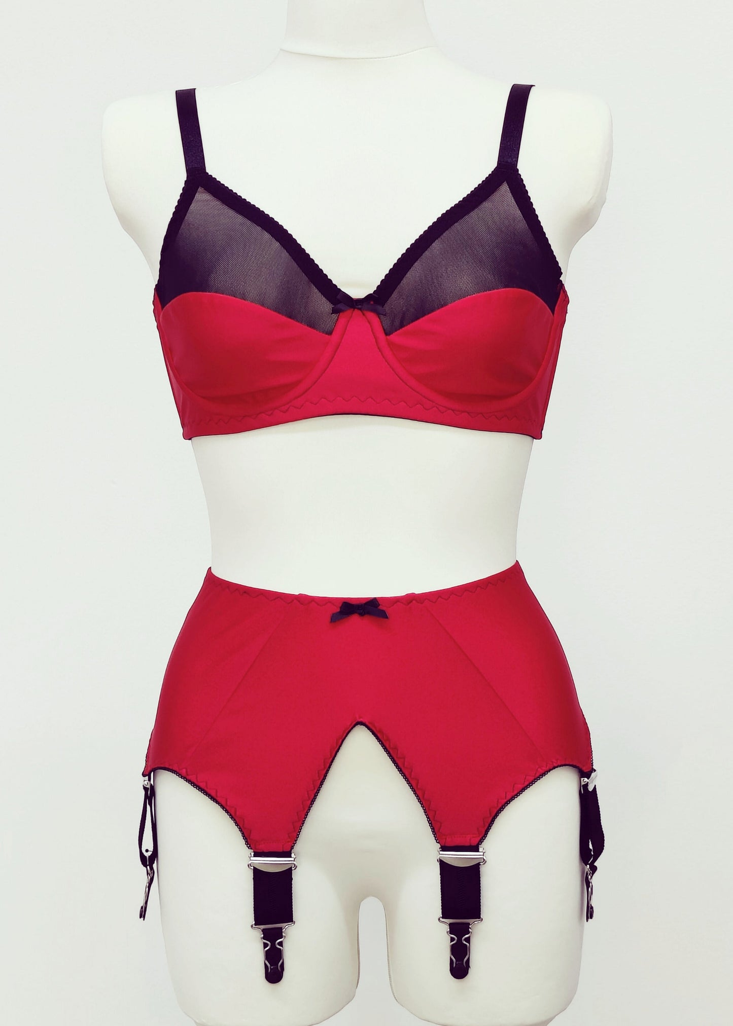 red Audrey bra with black sheer upper part of the cup, with matching red Iris garter belt