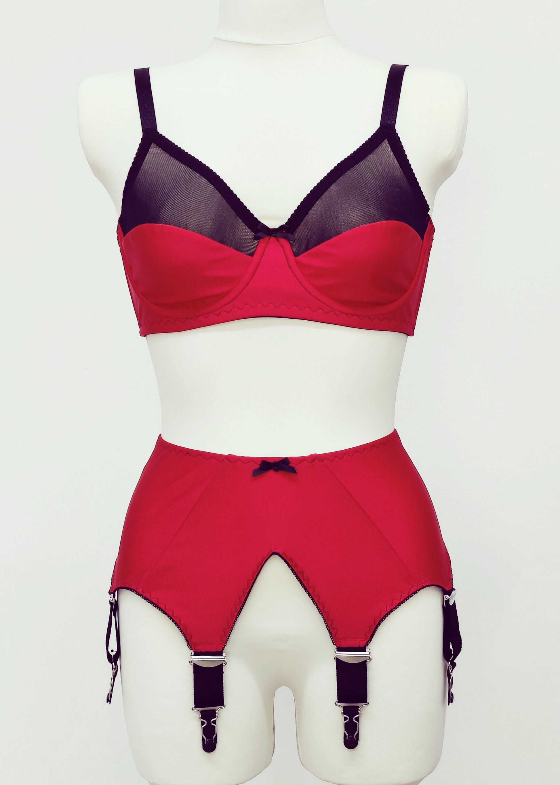 red Audrey bra with black sheer upper part of the cup, with matching red Iris garter belt
