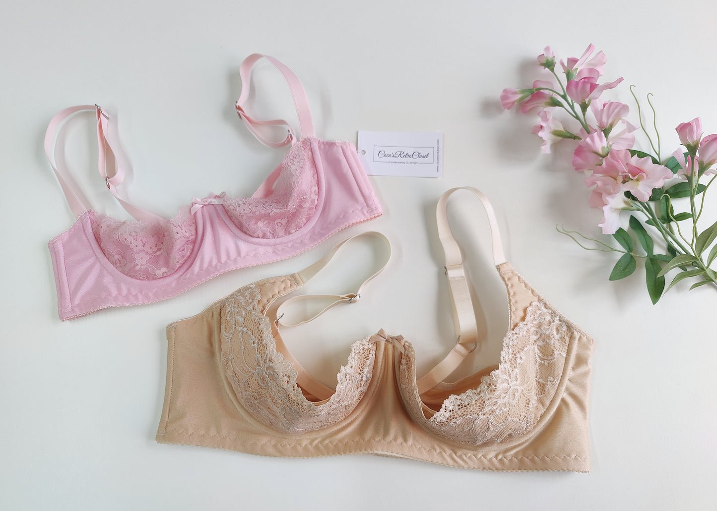Two quarter cup bras, one in pink and one in beige, displayed against a white background with a floral pattern. Both bras are designed with soft stretch lace, bra lining, and padding.