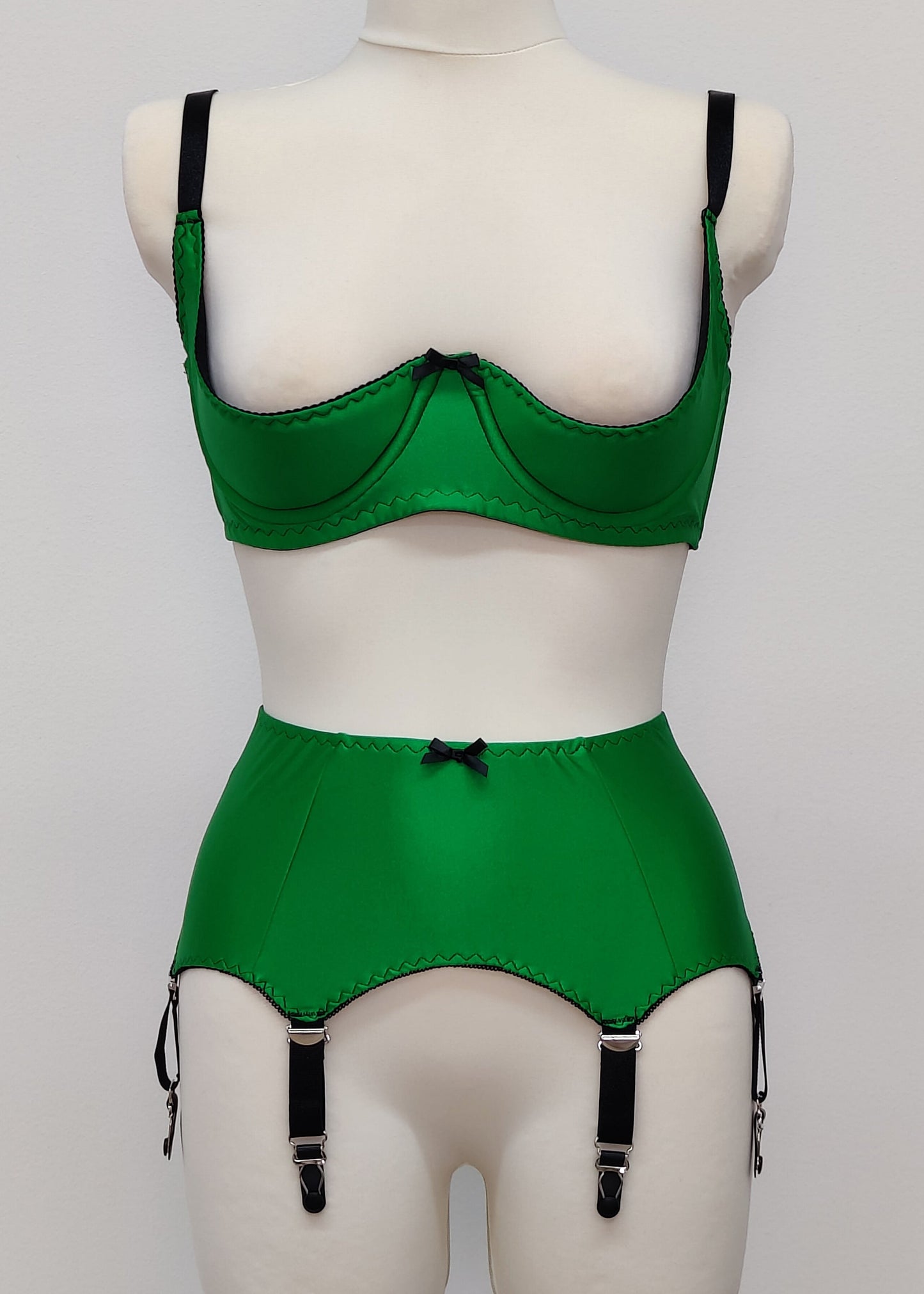 emerald green open quarter cup Gina bra with black straps and trim, shown with matching Greta garter belt