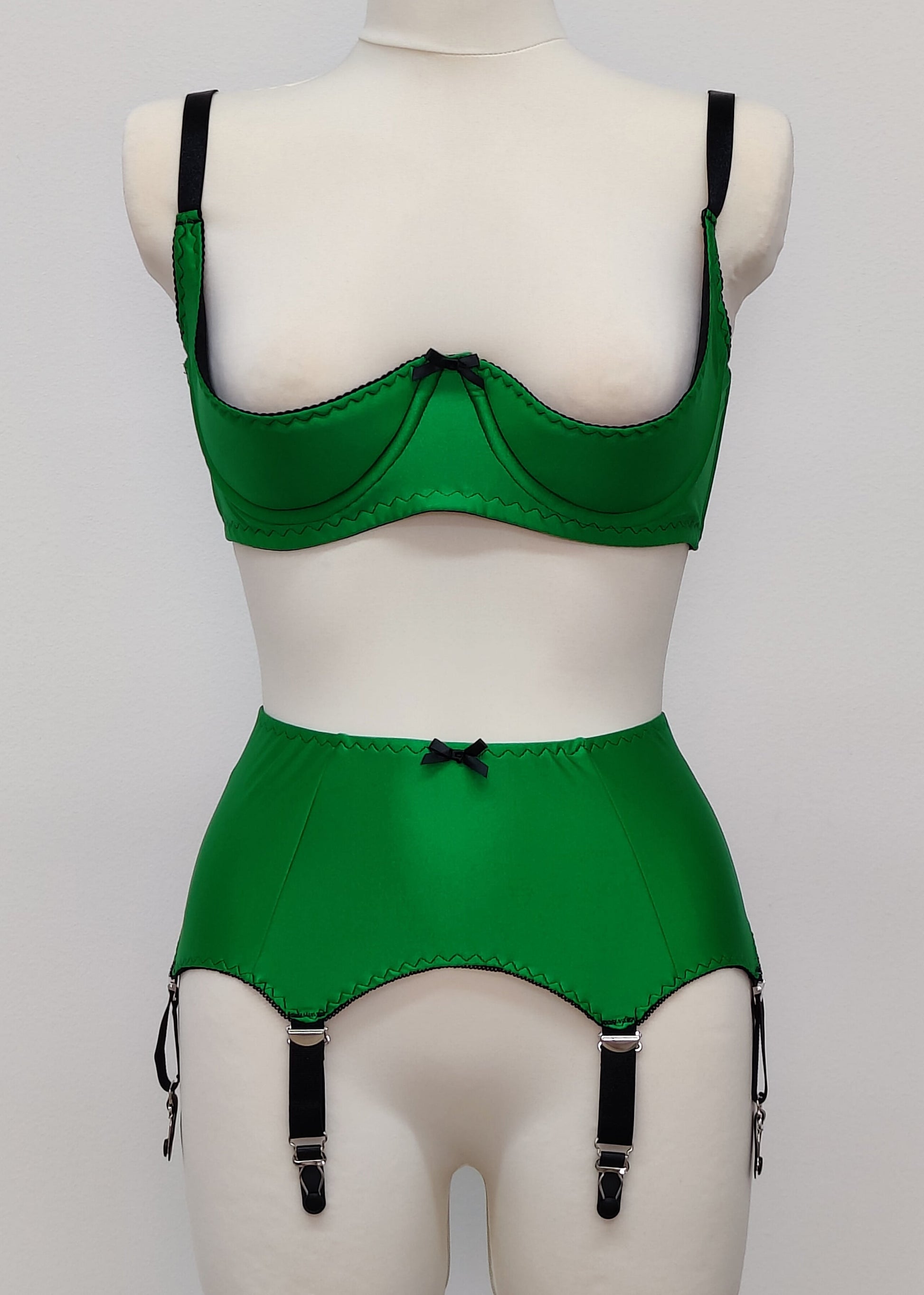 emerald green open quarter cup Gina bra with black straps and trim, shown with matching Greta garter belt