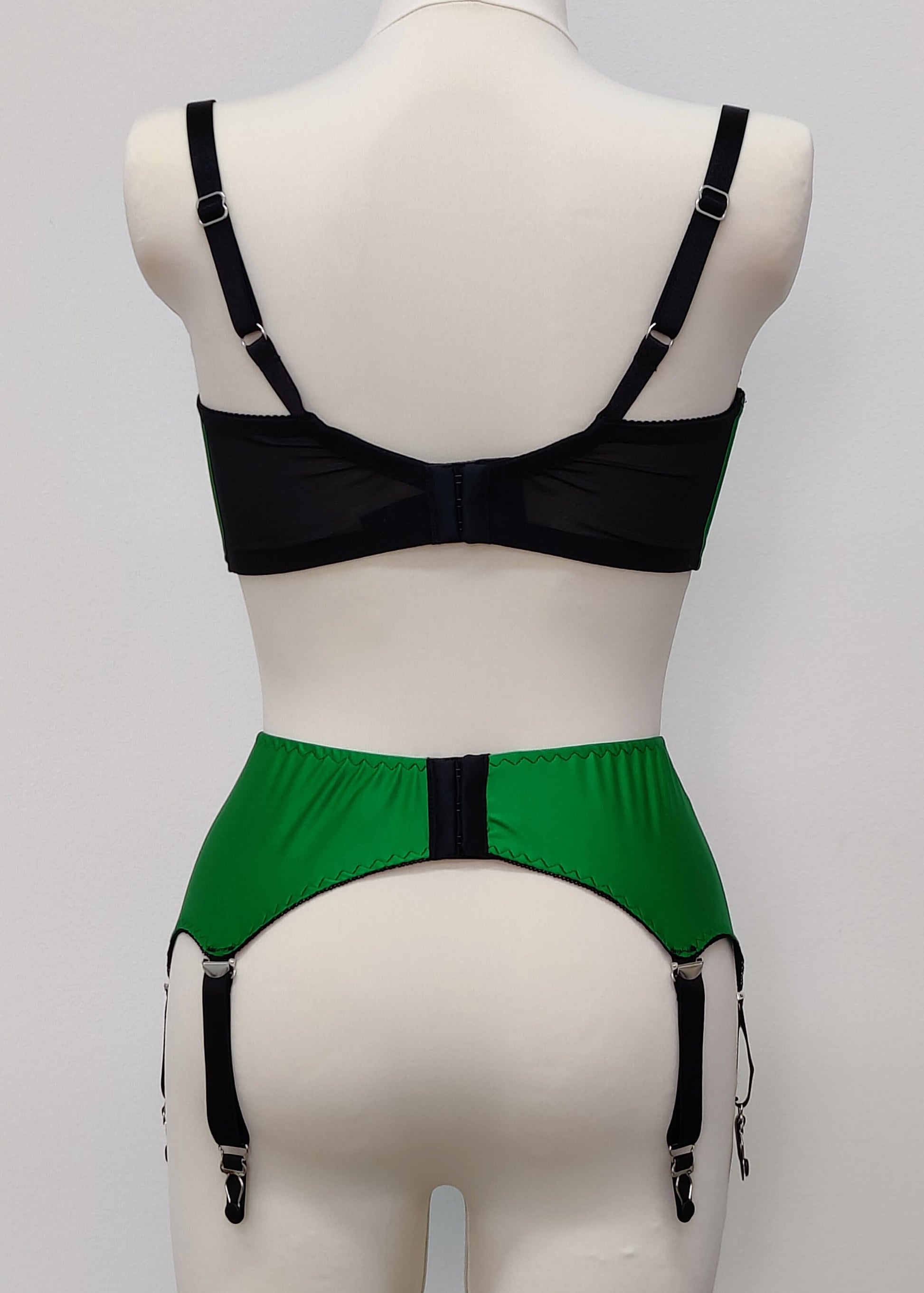 emerald green open quarter cup Gina bra with black straps and trim, shown with matching Greta garter belt, back view