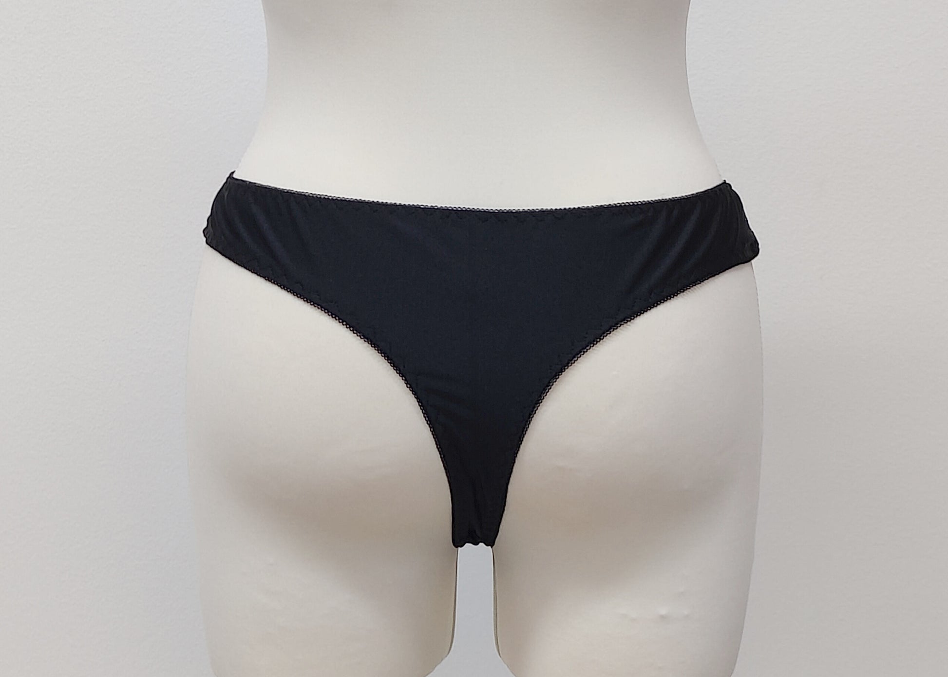 black bikini style Zigi thong panties with side lace panels, back view