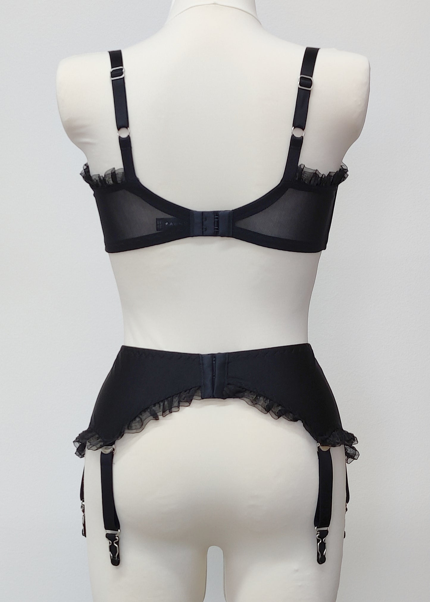 black 6 strap Gigi garter belt with ruffle trim, back view