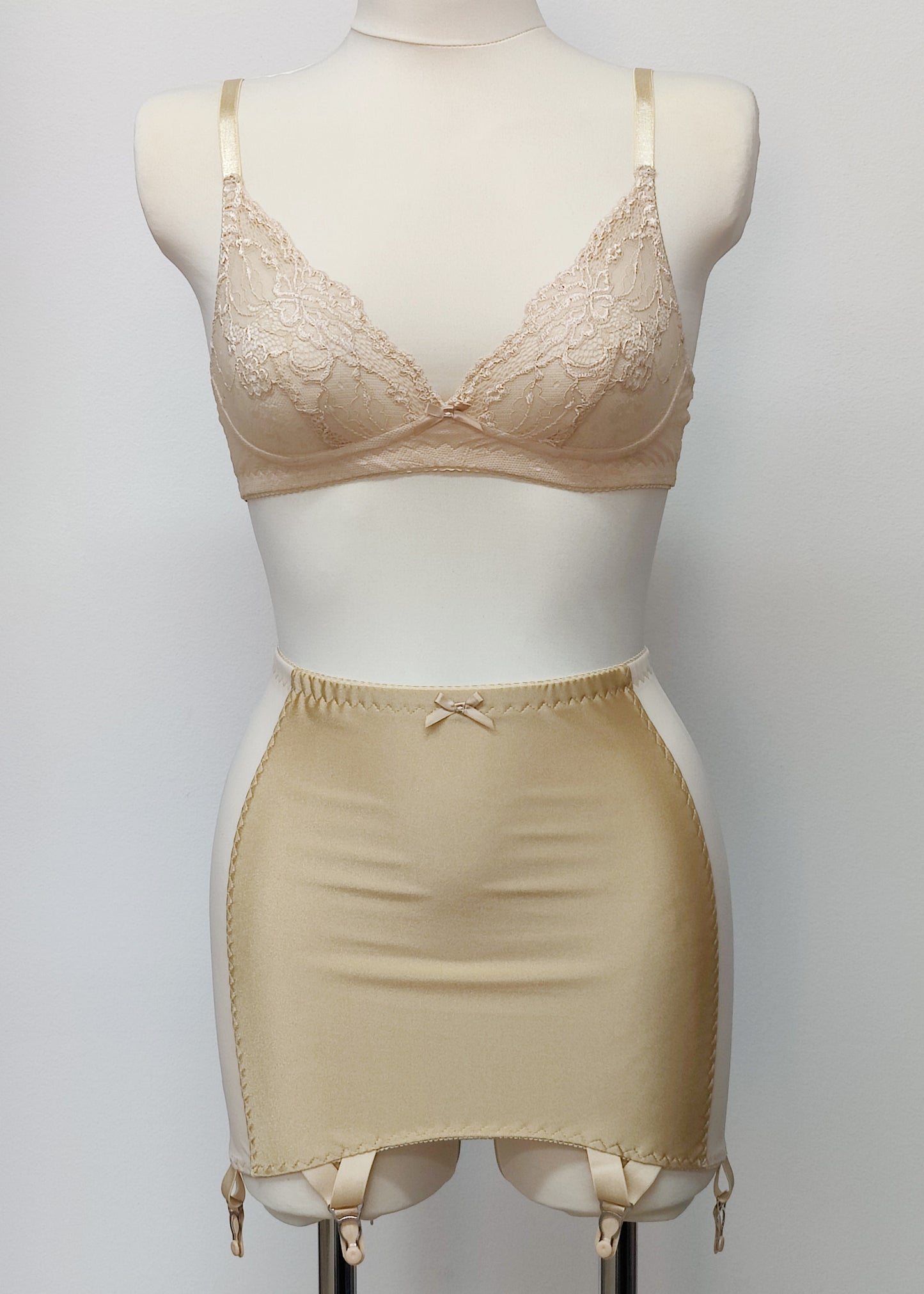 Beige smooth, light control, pull on girdle made with spandex and power mesh side panels. With 6 v style non-adjustable straps. You can have solid color girdle or mix of colors for just your own different girdle. Shown with beige lace Coco bralette