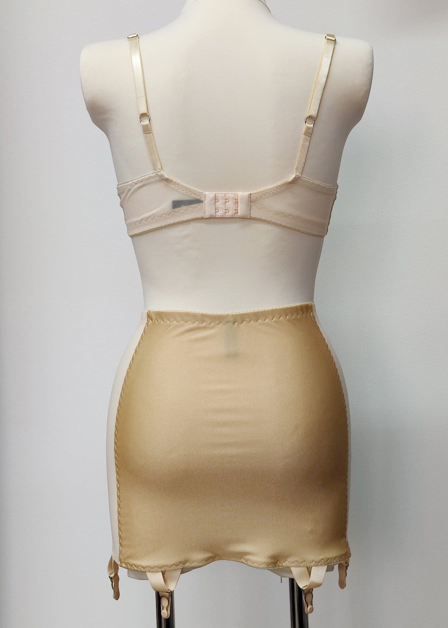 Beige smooth, light control, pull on girdle made with spandex and power mesh side panels. With 6 v style non-adjustable straps. You can have solid color girdle or mix of colors for just your own different girdle. back view