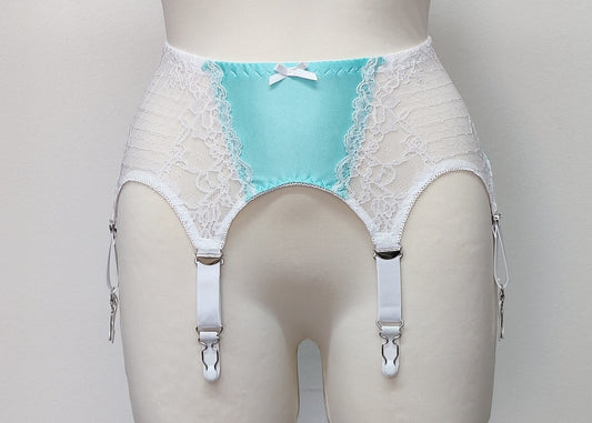 A white lace and Aqua blue Lycra, Mona garter belt with 6 adjustable straps and hook and eye closure, displayed on a mannequin.