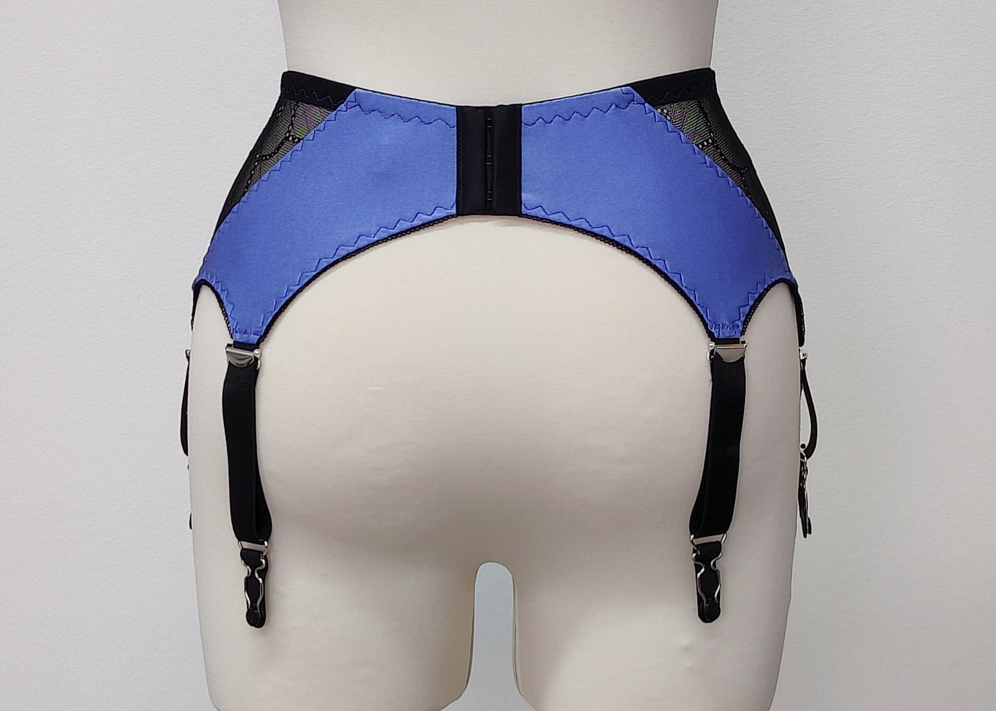 lavender blue high waist retro style Mona garter belt with black lace side panels and 6 straps, back view