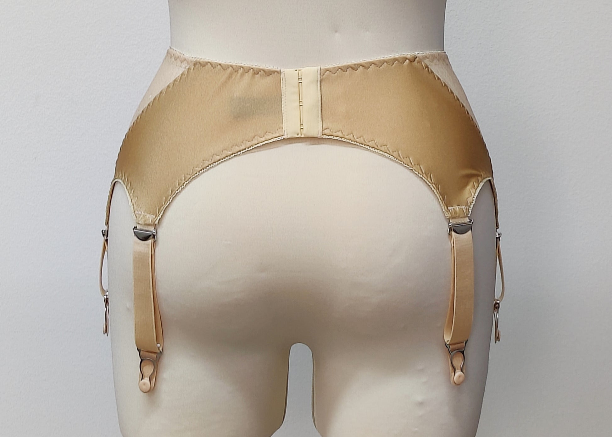 Beige 6 strap retro style garter belt with side lace panels, back view