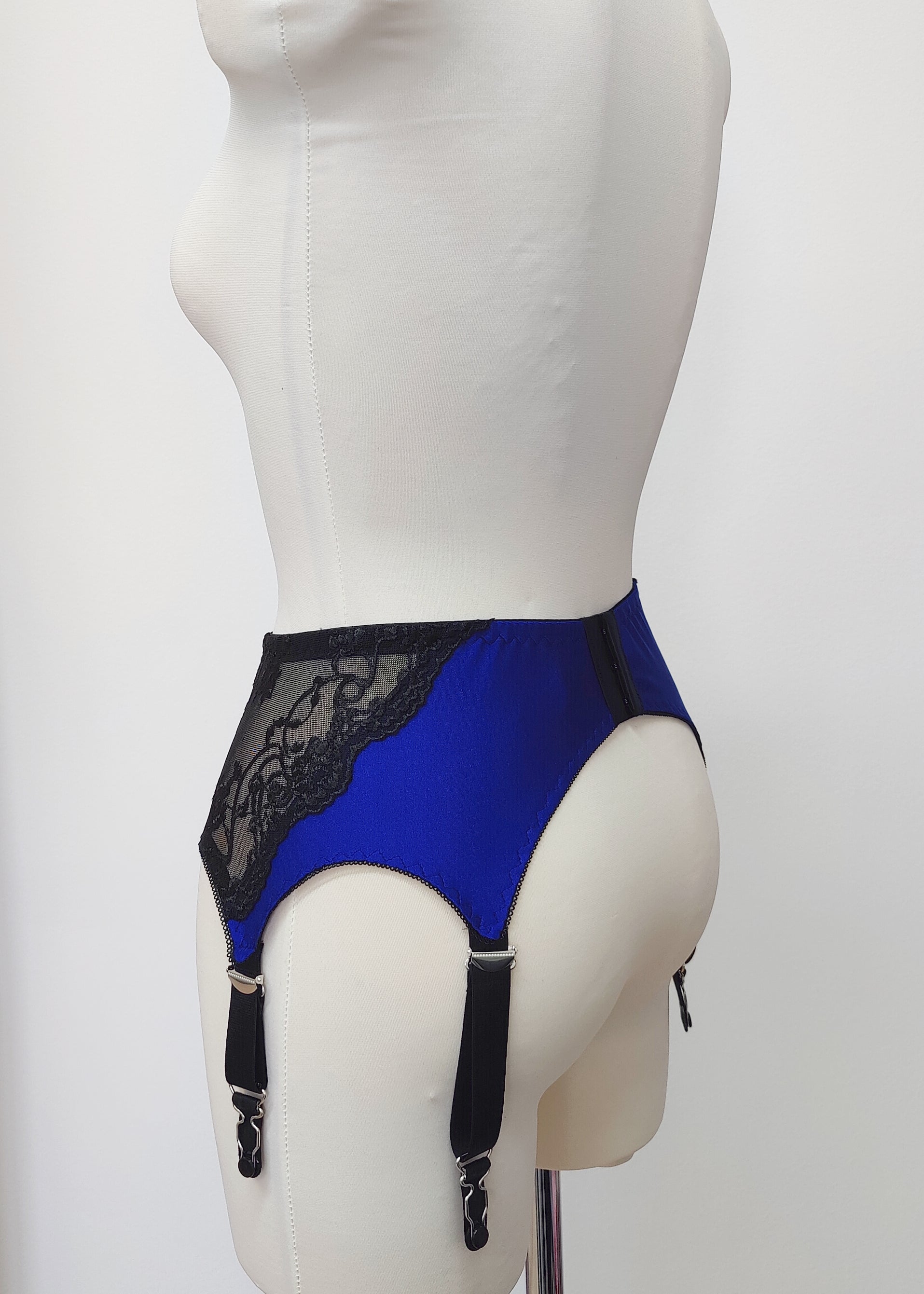 blue high waist retro style Mona garter belt with black lace side panels and 6 straps, side view