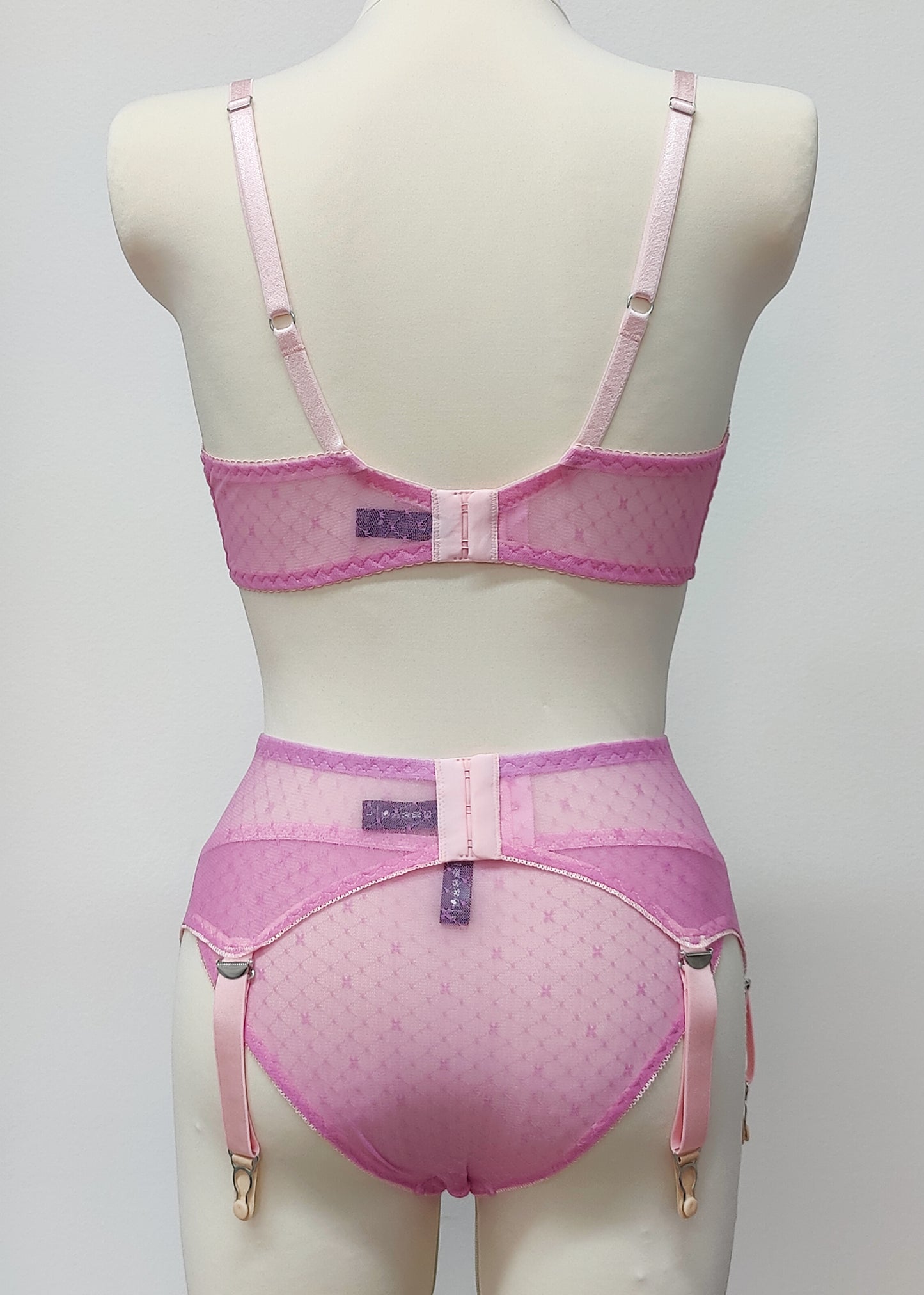 pink sheer string bikini panties made with lingerie mesh with tiny X pattern, shown with matching Chloe bralette and Lula garter belt, back view