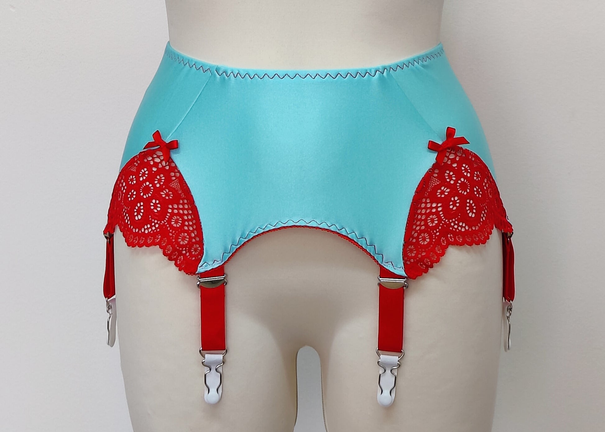 custom made, light blue 6 strap Scarlett garter belt with red straps and lace side inserts