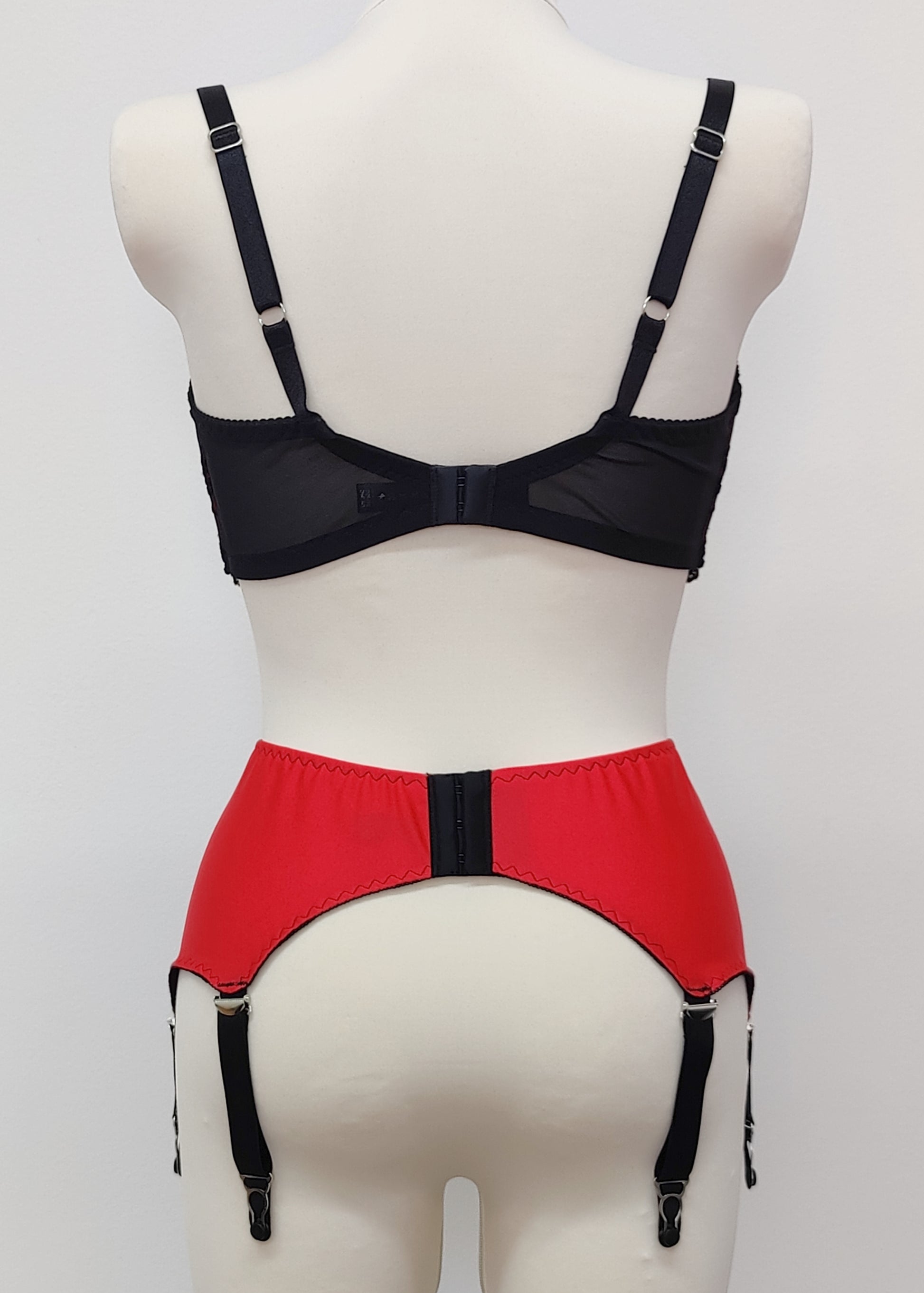 red 6 strap Scarlett garter belt with black straps and lace side inserts, shown with matching bra, back view