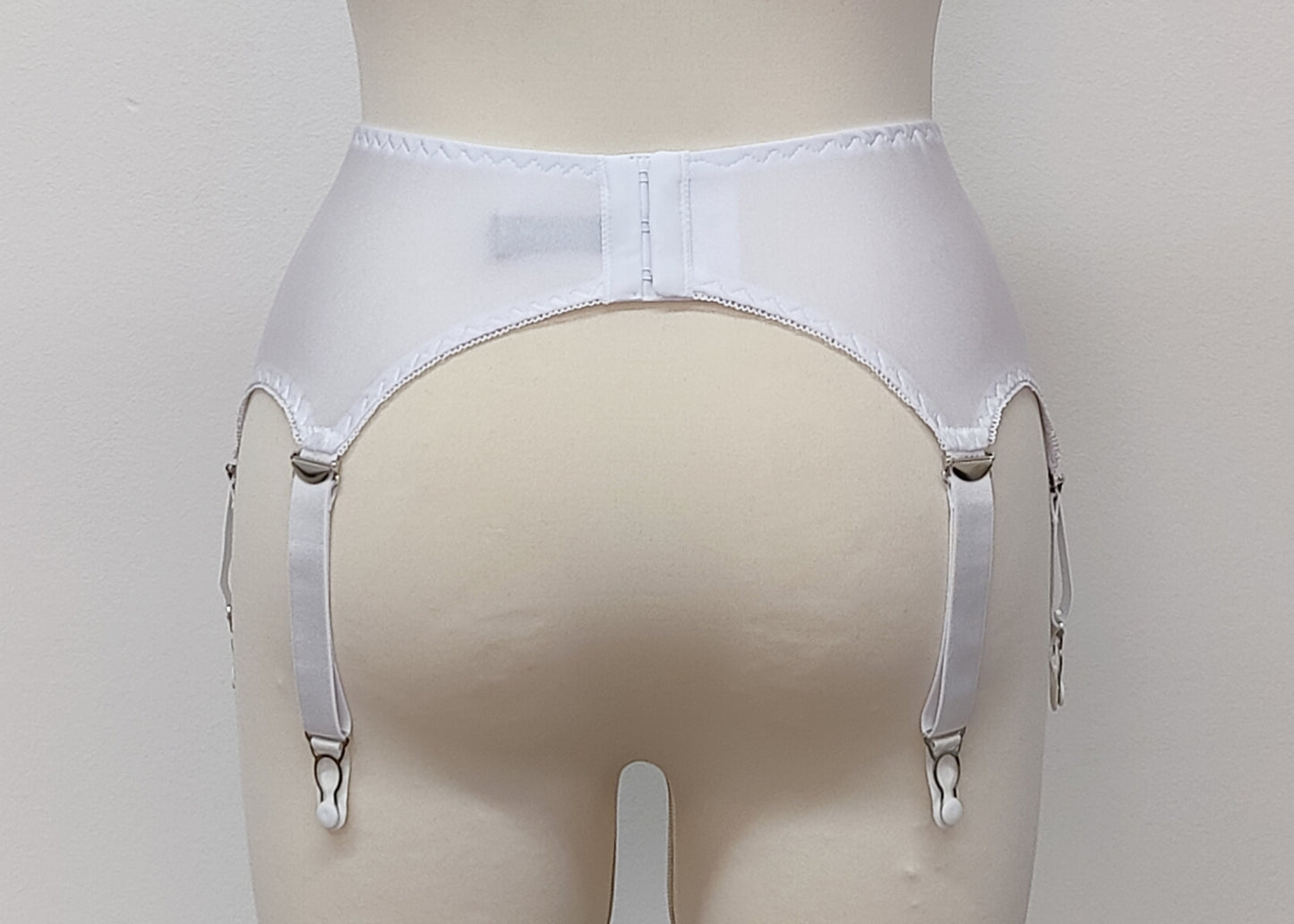 White narrow Nina garter belt, 60's style with 6 adjustable straps and hook and eye closure at the back. back view