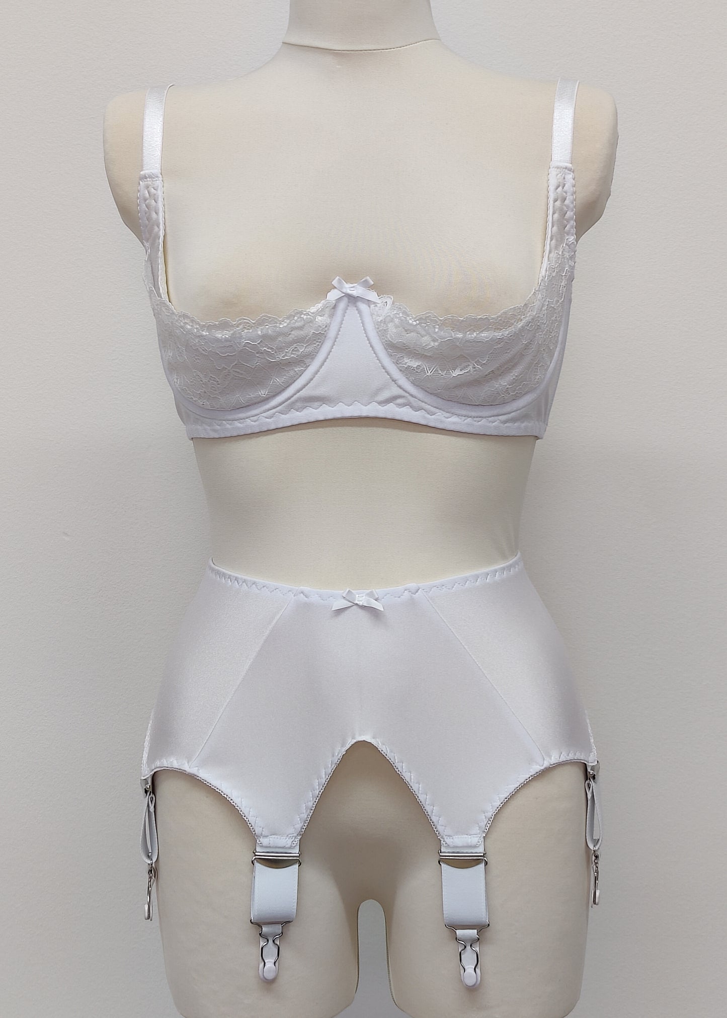 White wide Iris garter belt with a deep V-style design, featuring six extra wide adjustable straps, shown with matching white lace Lucy quarter cup bra