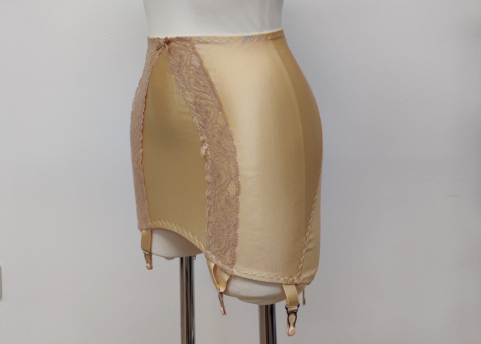 beige 6 strap Rhonda open bottom girdle, with sheer back and lace trim on the front, side view