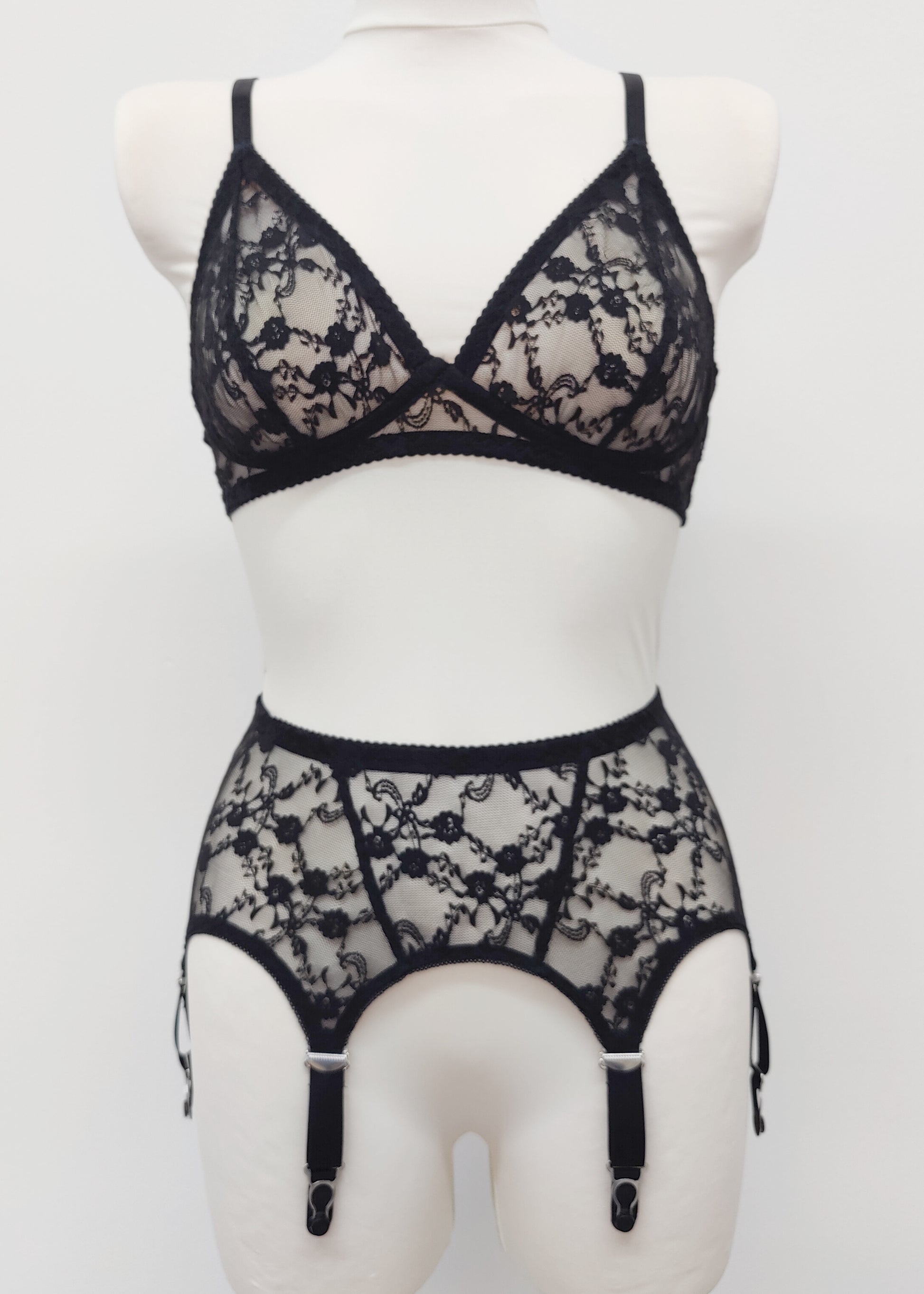 Claire is a black lace garter belt with 4-8 adjustable straps, displayed on a mannequin with matching wireless Chloe bralette