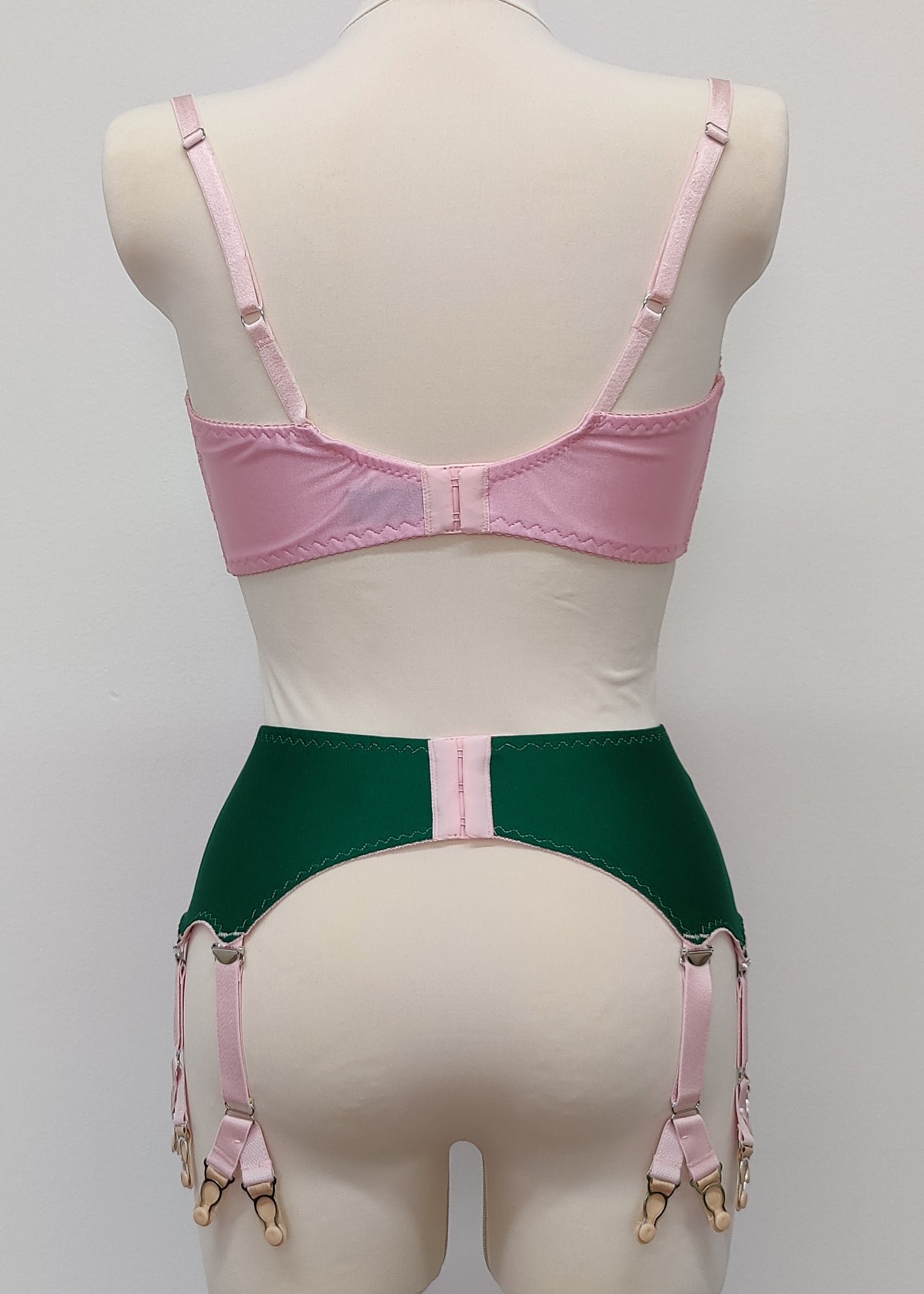 emerald green Jean garter belt with 8 pink Y-straps, shown with pink Lucrezia quarter cup bra, back view