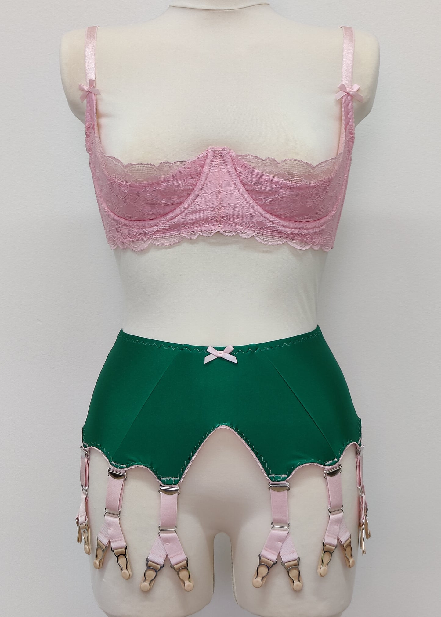 emerald green Jean garter belt with 8 pink Y-straps, shown with pink Lucrezia quarter cup bra