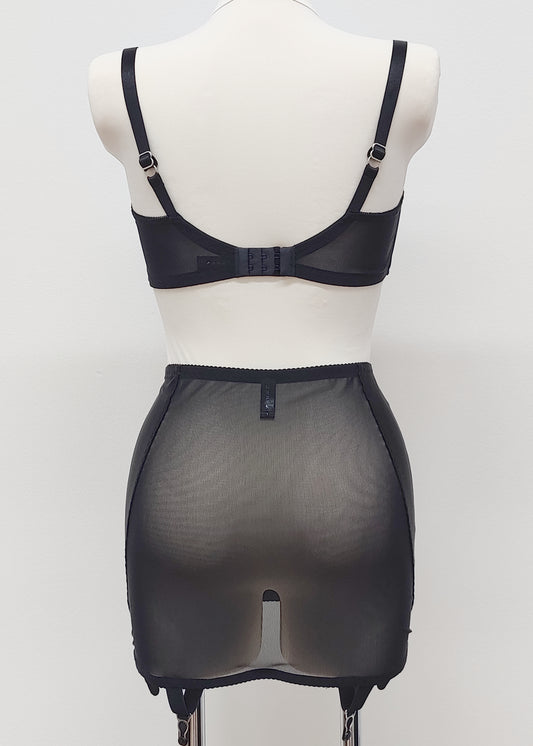 black 6 strap Rhonda open bottom girdle, with sheer back and silvery lace trim on the front, shown with black Gina quarter cup bra, back view