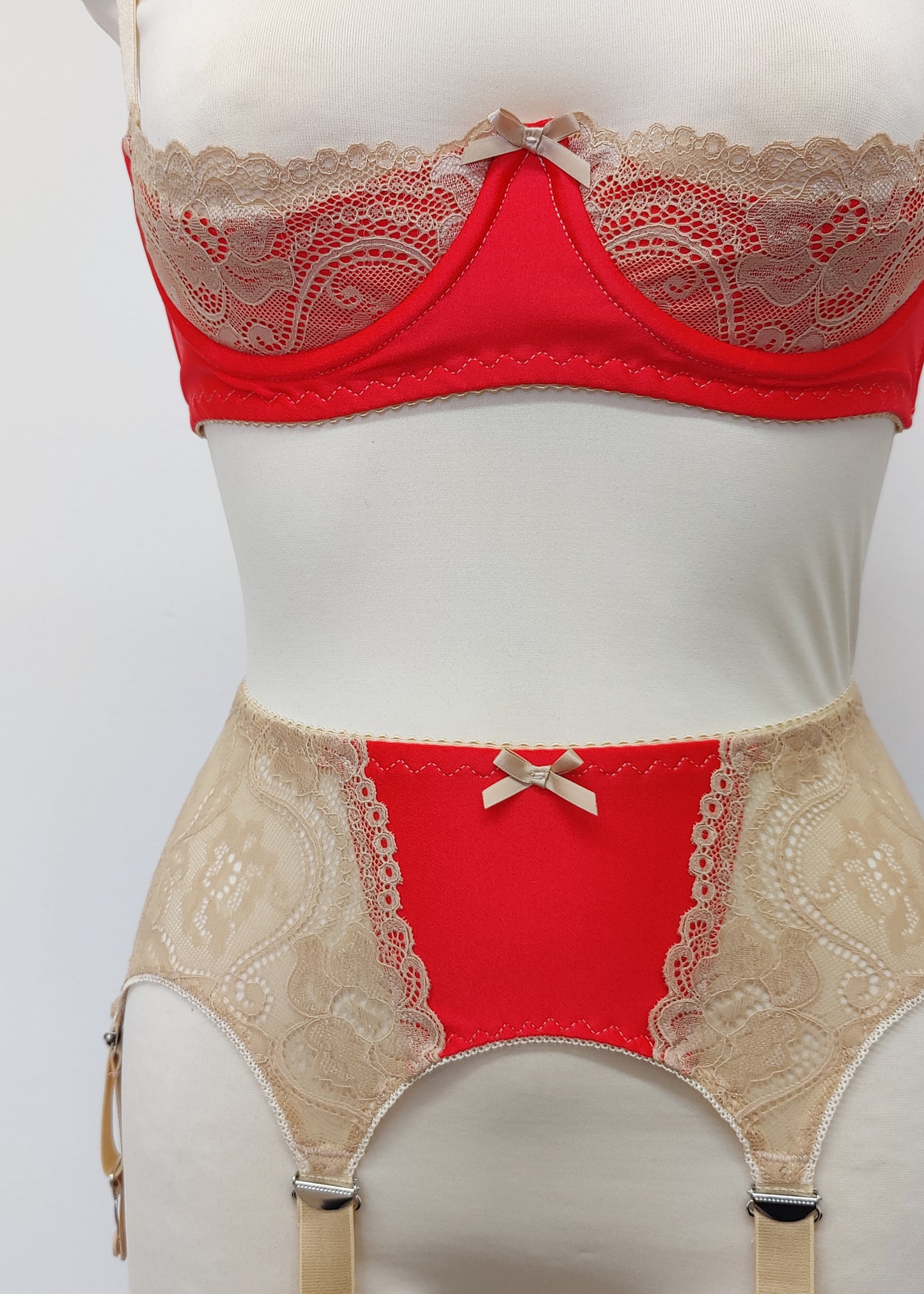 Red quarter cup Lucy bra with beige lace, straps and trims, here shown with matching retro style Mona garter belt , detail