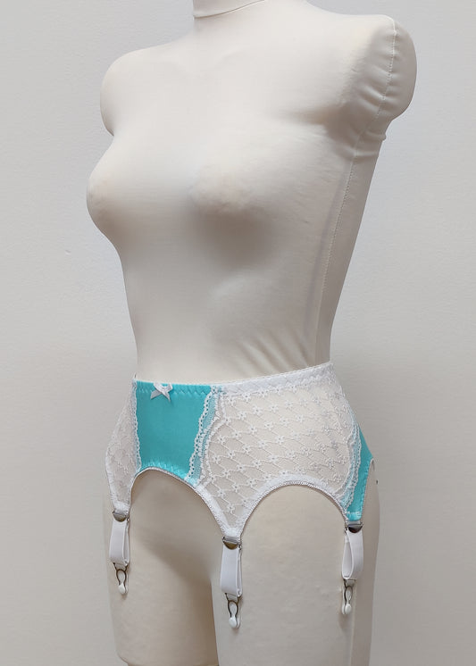 A white lace and Aqua blue Lycra, Mona garter belt with 6 adjustable straps and hook and eye closure, displayed on a mannequin, side view