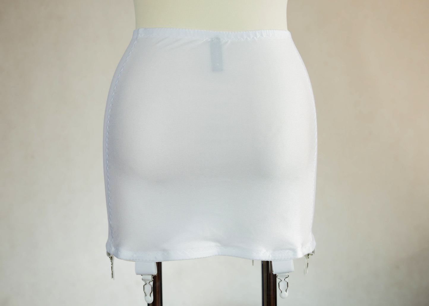 White smooth, light control, pull on girdle made with spandex and power mesh side panels. With 6 v style non-adjustable straps. You can have solid color girdle or mix of colors for just your own different girdle. back view
