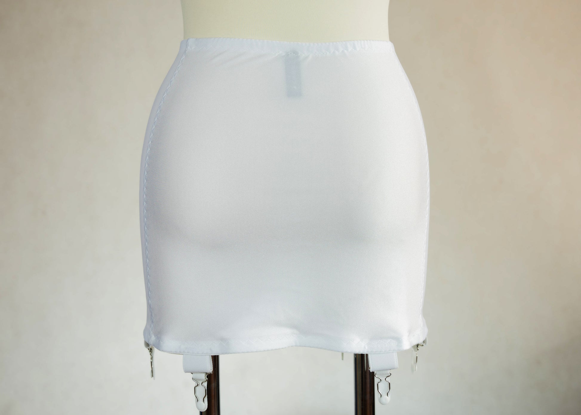 White smooth, light control, pull on girdle made with spandex and power mesh side panels. With 6 v style non-adjustable straps. You can have solid color girdle or mix of colors for just your own different girdle. back view