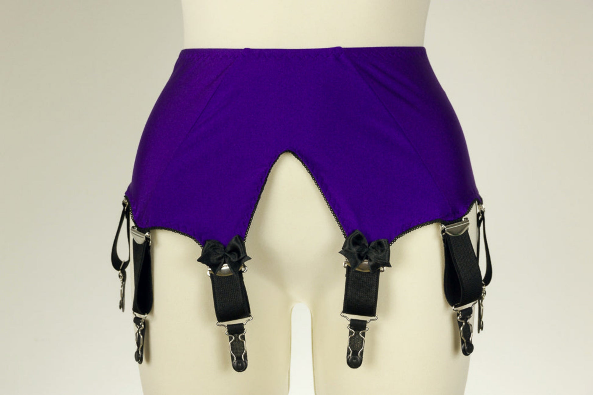 wide vintage style Iris garter belt, purple with extra wide black straps, with larger bows on the front straps