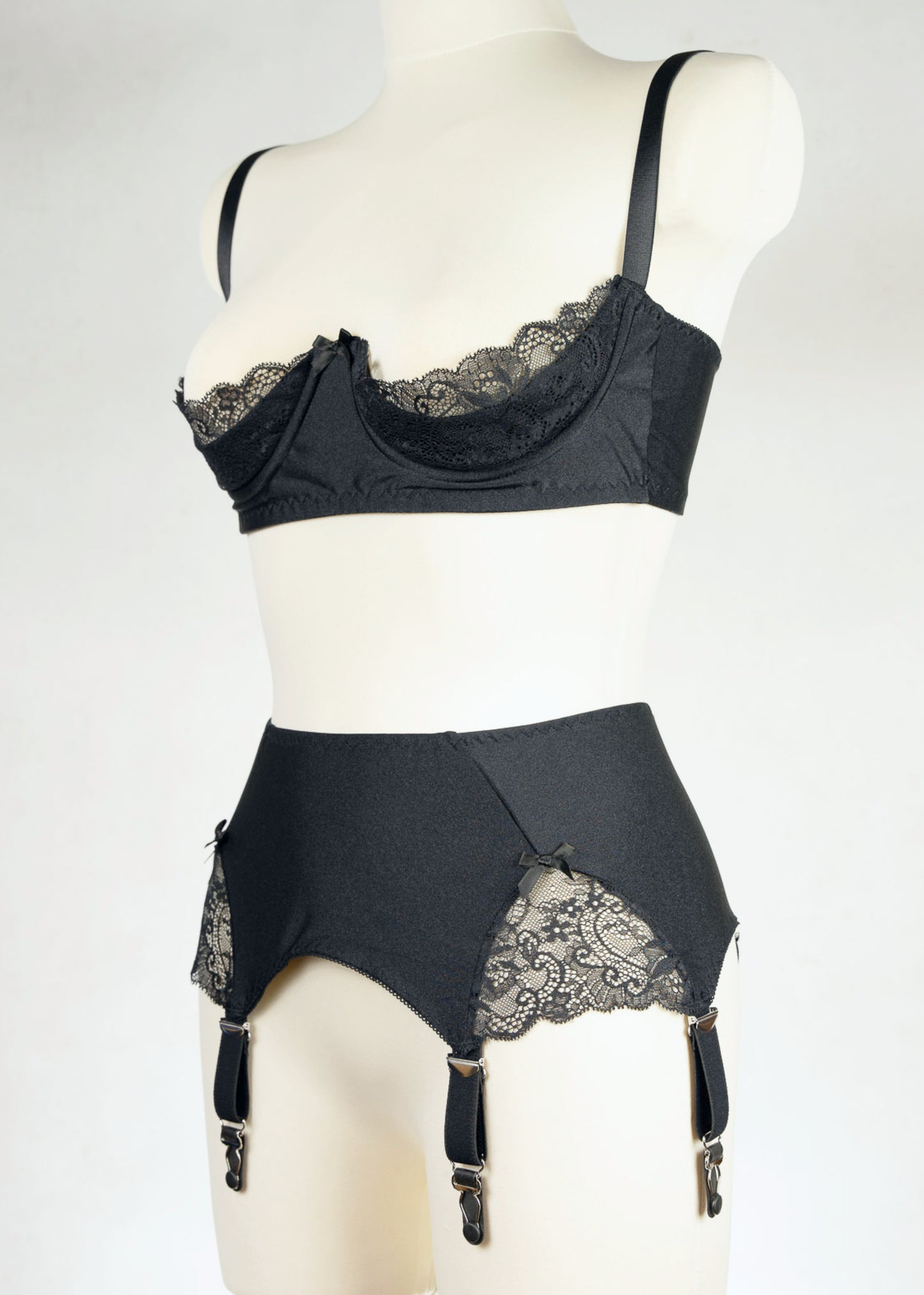 black, retro style, 6 strap Scarlett garter belt with black straps and lace side inserts, shown with matching Lucy quarter cup bra, side view