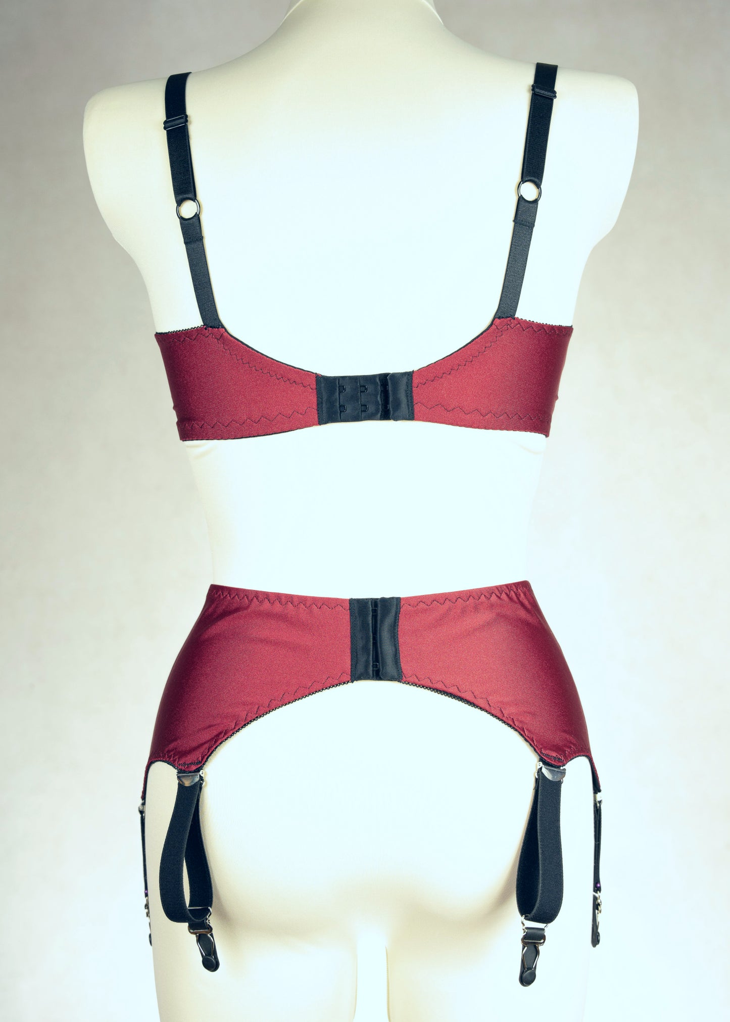 dark red retro style, 6 strap Scarlett garter belt with black straps and lace side inserts, shown with matching Lucy quarter cup bra, back view