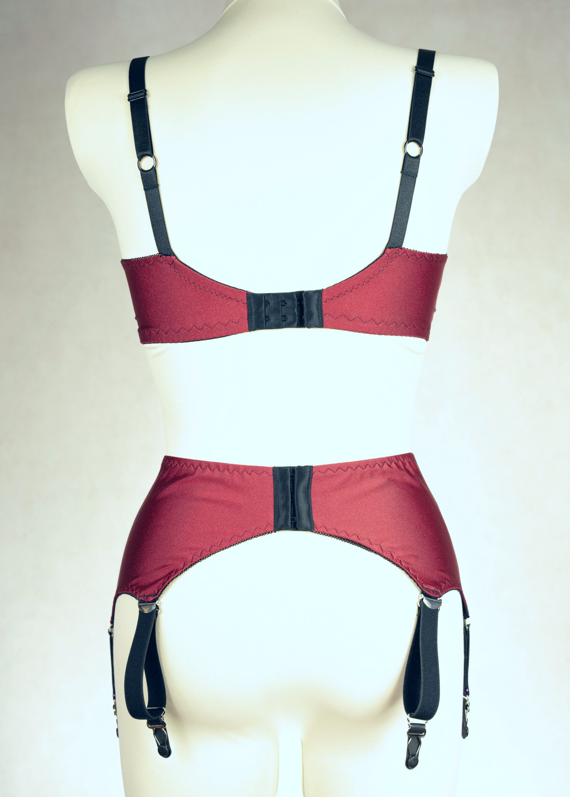 dark red retro style, 6 strap Scarlett garter belt with black straps and lace side inserts, shown with matching Lucy quarter cup bra, back view