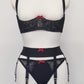 black swirl patterned mesh, quarter cup bra with red bow