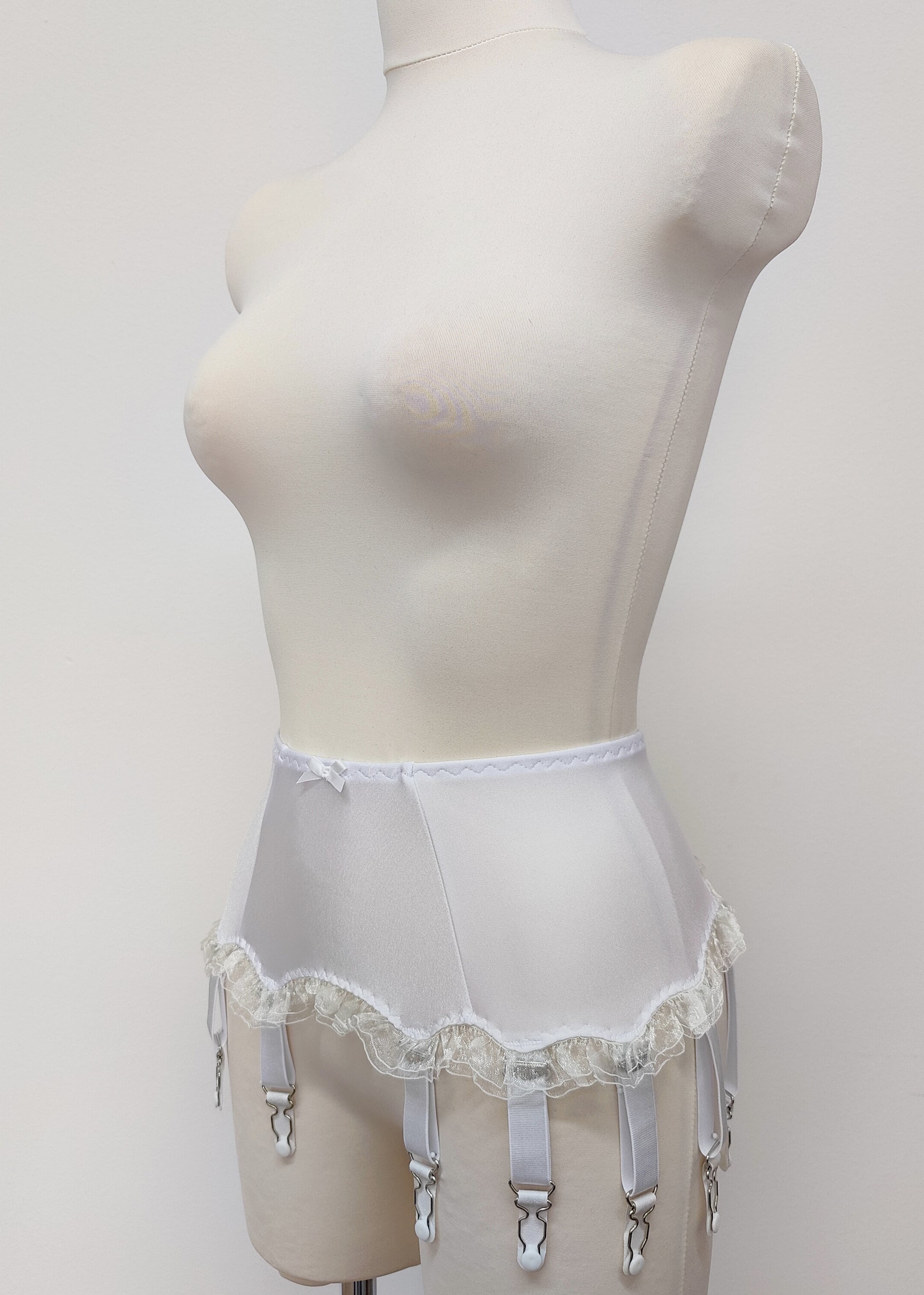 White 10 strap Gigi garter belt with ruffle trim, side view