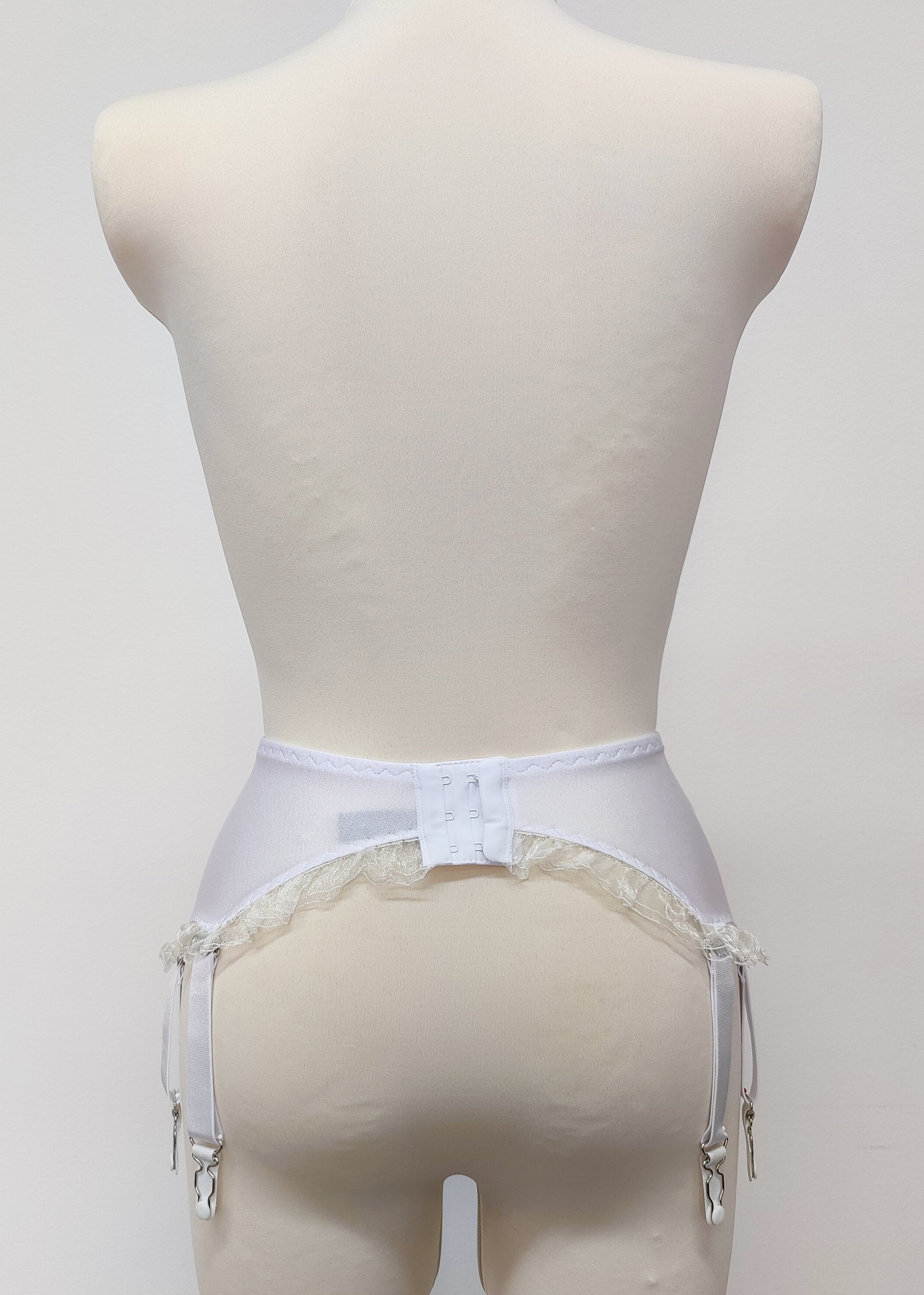 White 10 strap Gigi garter belt with ruffle trim, back view