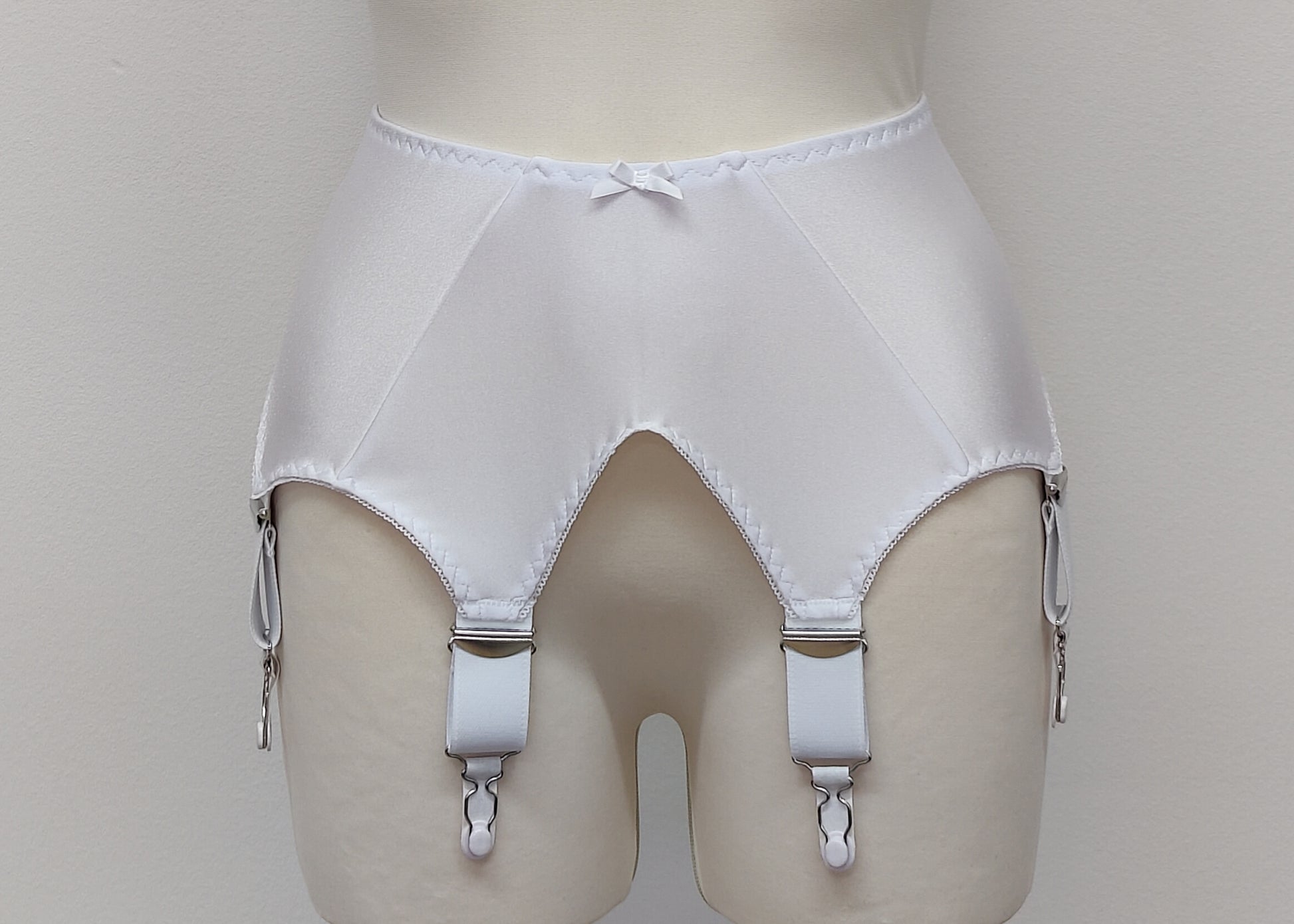 White wide Iris garter belt with a deep V-style design, featuring six extra wide adjustable straps