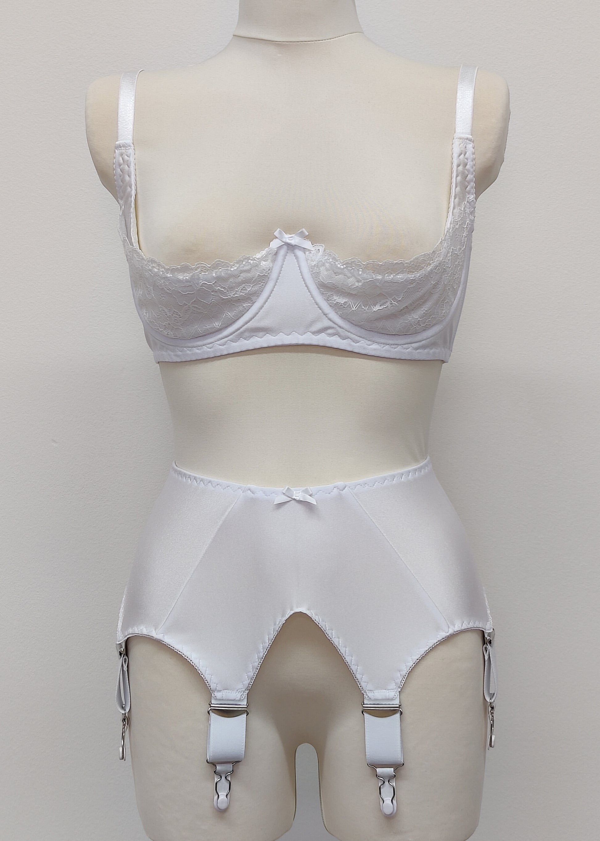 White wide Iris garter belt with a deep V-style design, featuring six extra wide adjustable straps, shown with matching white lace Lucy quarter cup bra