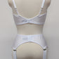 White wide Iris garter belt with a deep V-style design, featuring six extra wide adjustable straps, shown with matching white bra, back view
