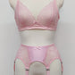 Pink lace  Mona garter belt with 6 adjustable straps and hook and eye closure, displayed on a mannequin with matching bralette