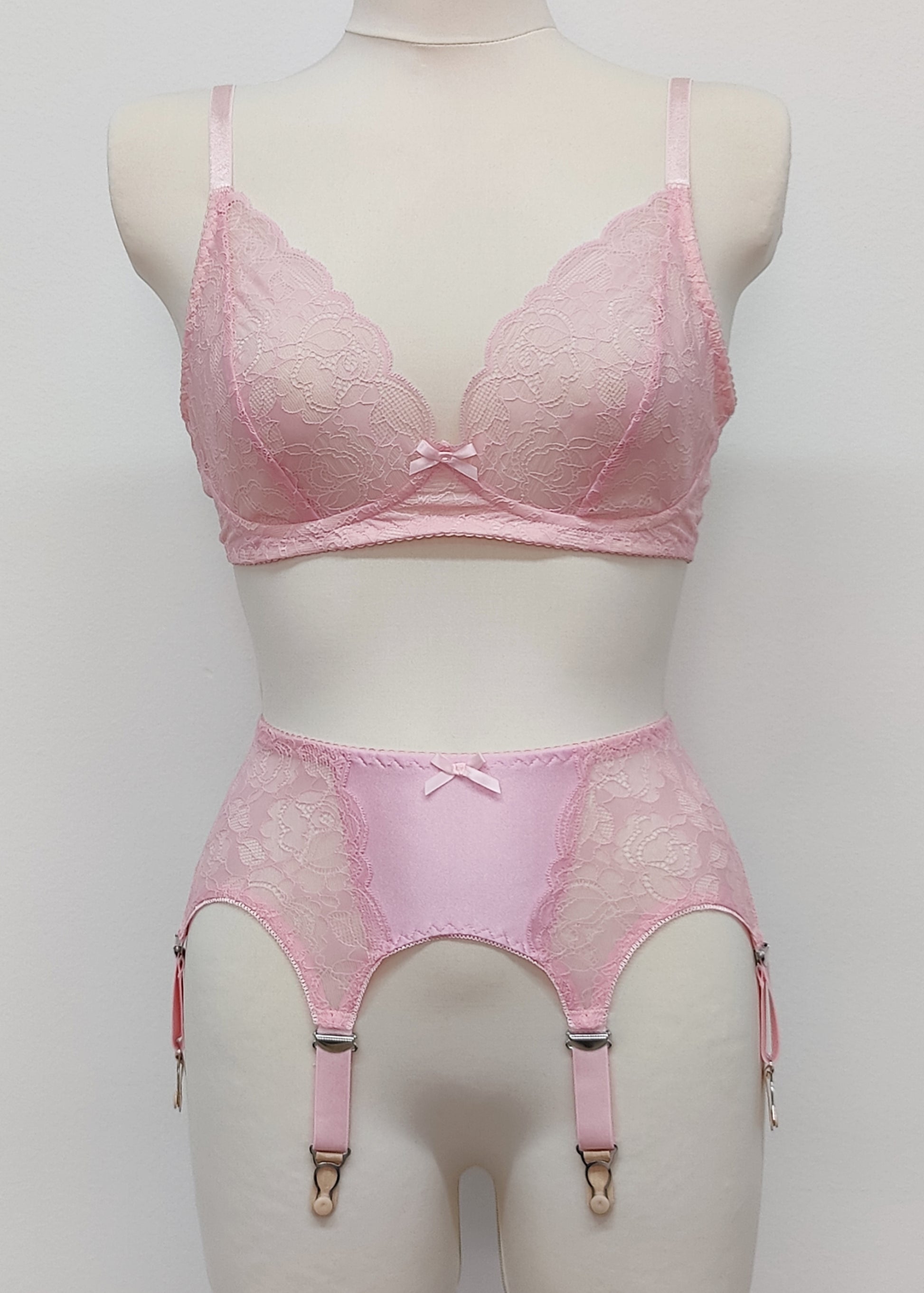 Pink lace  Mona garter belt with 6 adjustable straps and hook and eye closure, displayed on a mannequin with matching bralette