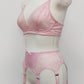 Pink lace  Mona garter belt with 6 adjustable straps and hook and eye closure, displayed on a mannequin with matching bralette, side view