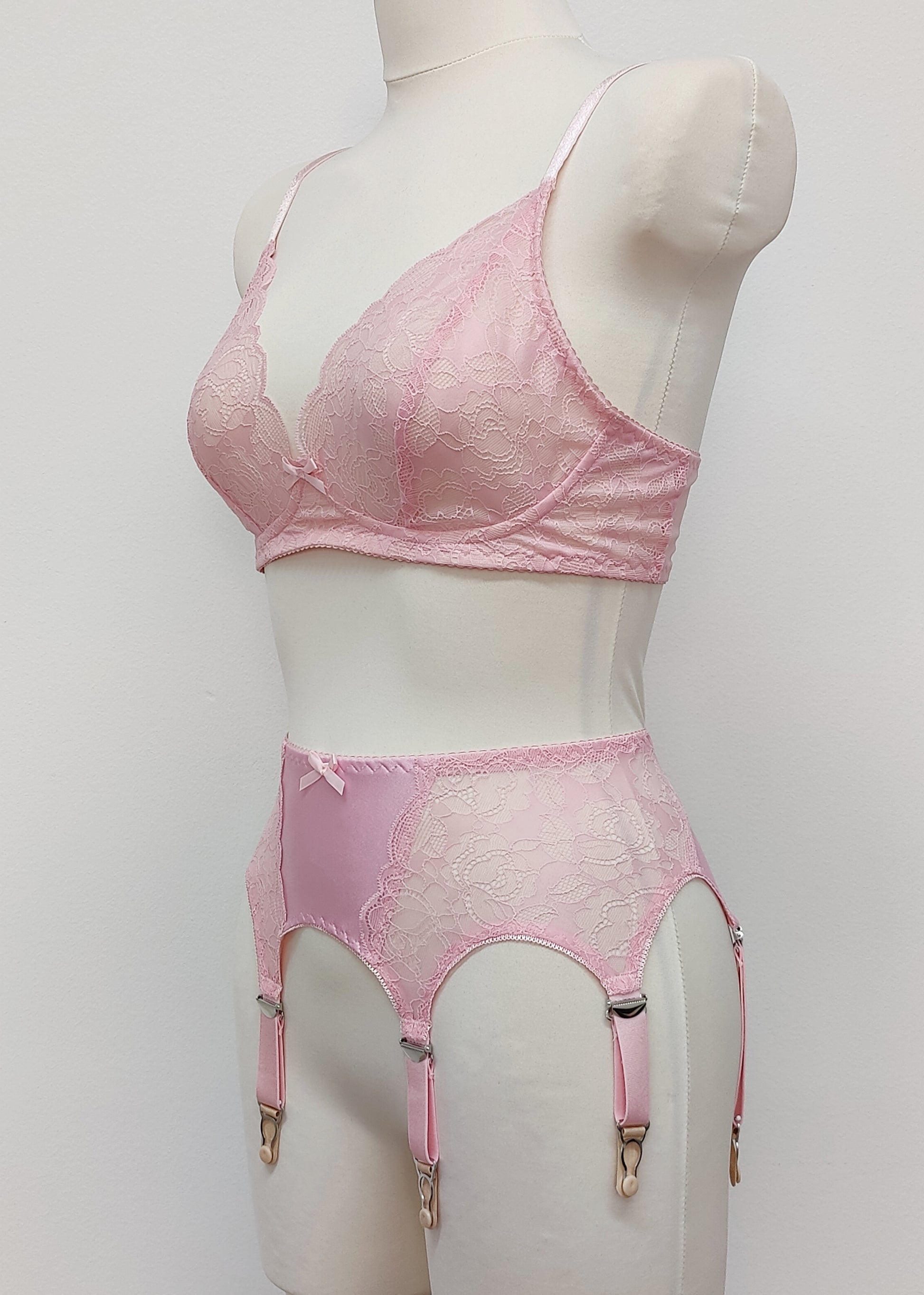 Pink lace  Mona garter belt with 6 adjustable straps and hook and eye closure, displayed on a mannequin with matching bralette, side view