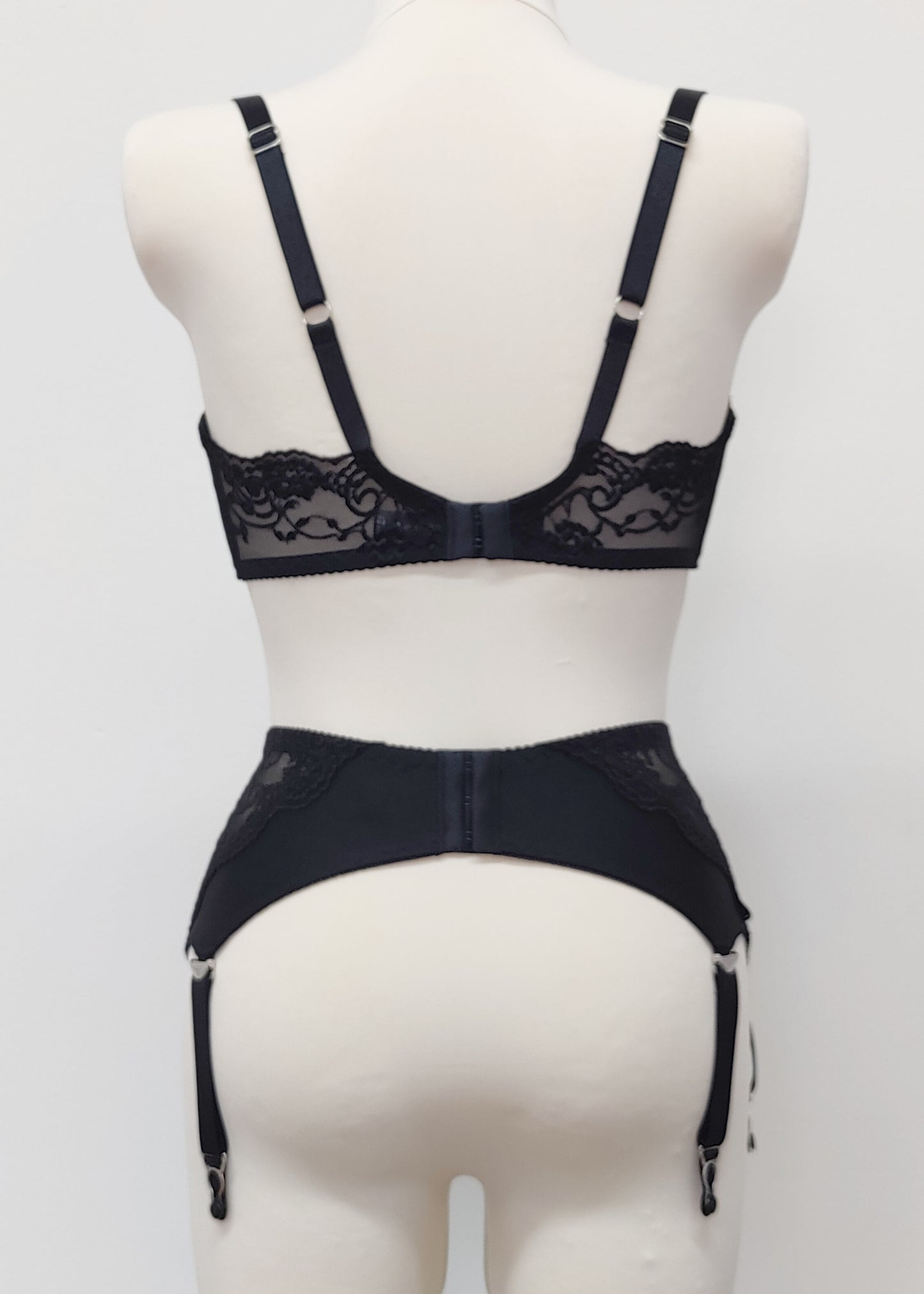 wide retro style Liliane garter belt with  6 wide straps and black lace side panels, with matching bra, back view