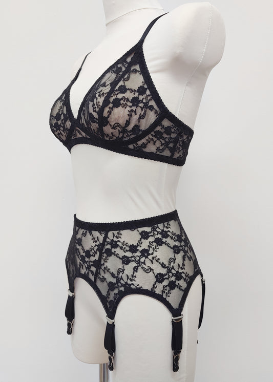 Claire is a black lace garter belt with 4-8 adjustable straps, displayed on a mannequin with matching wireless Chloe bralette, side view